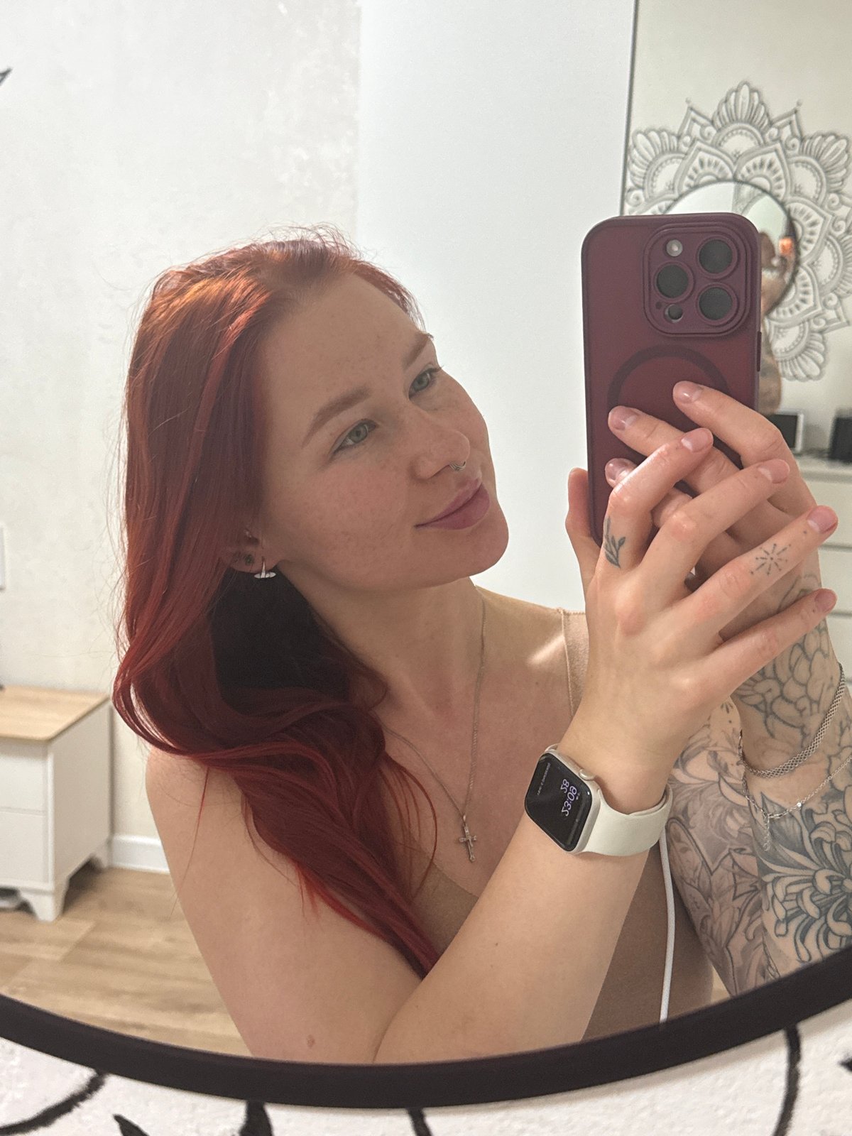 Woman photographs herself in candlelit indoor portraits in Rostov-on-Don