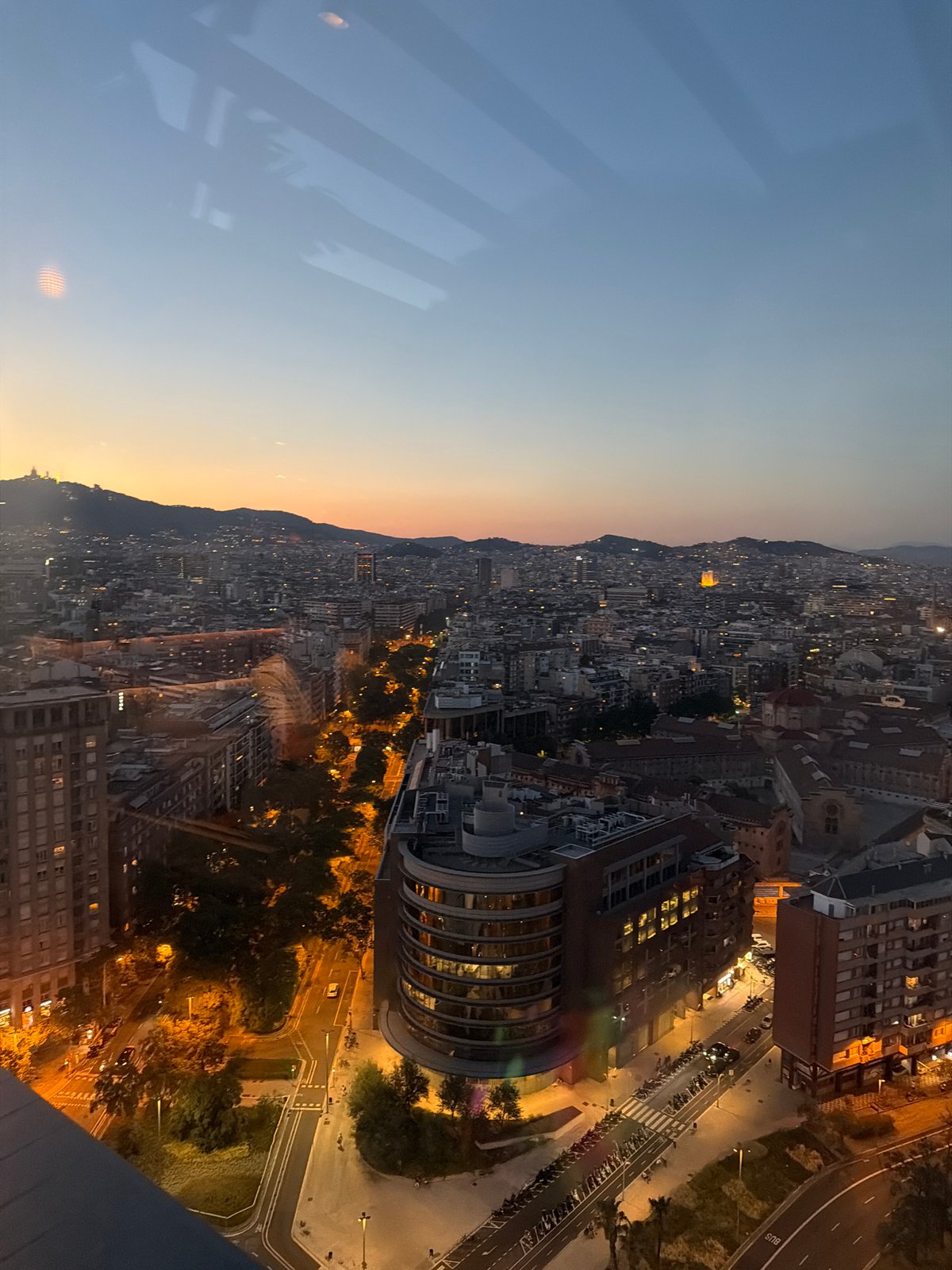 Rooftop evening in Barcelona with skyline and moonrise