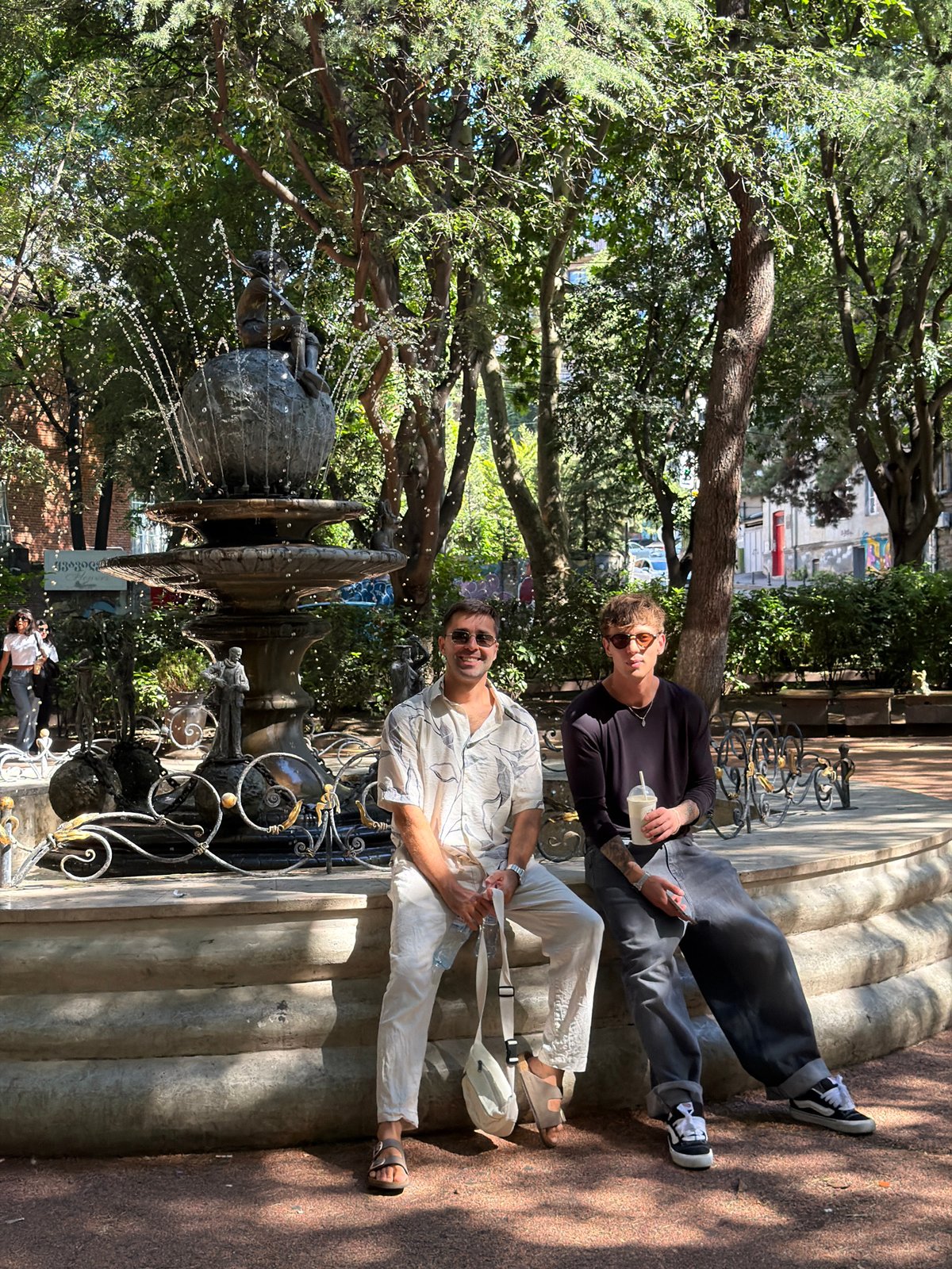 Afternoon in a Tbilisi park, around an ornate stone fountain