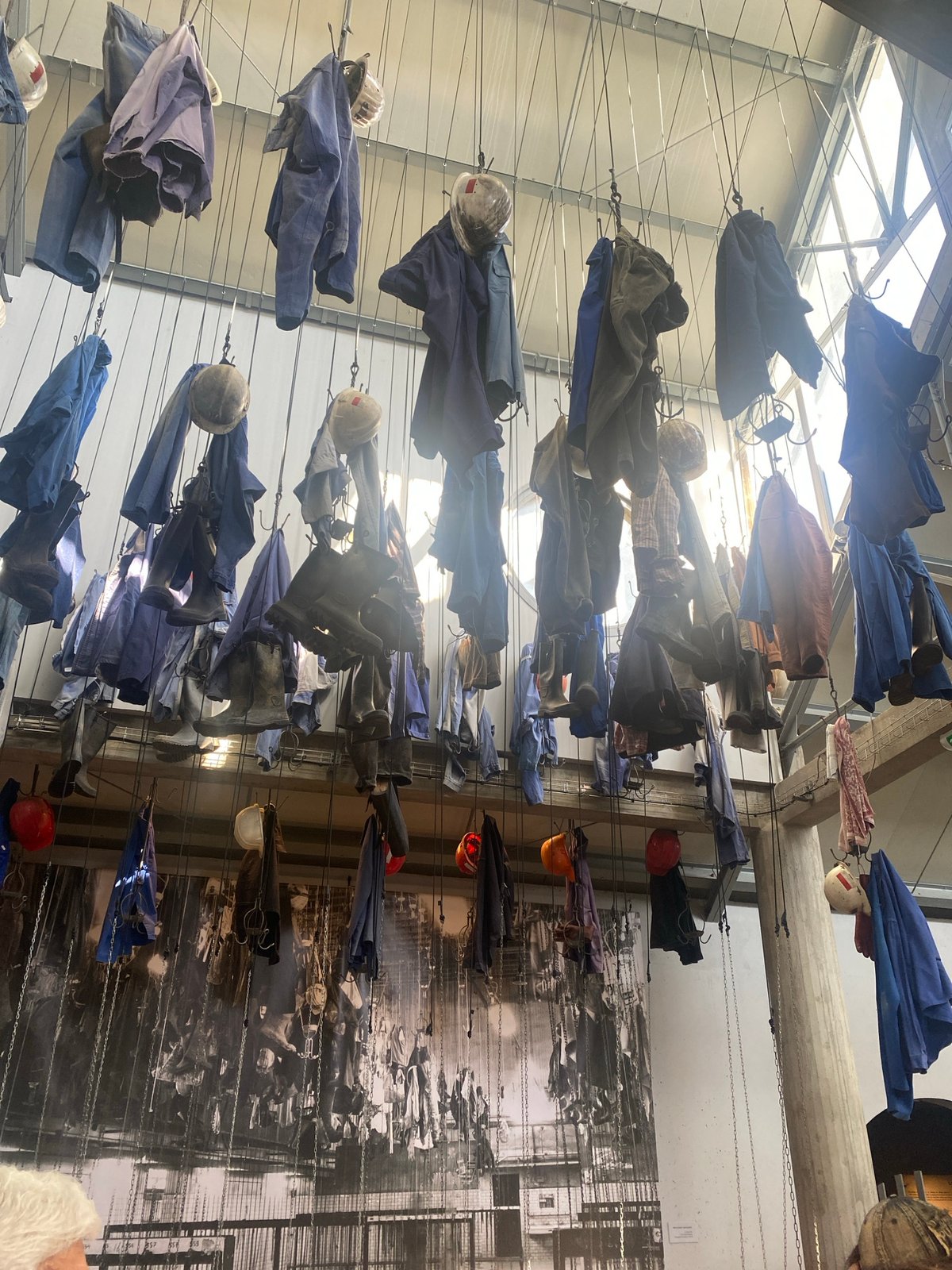Mining heritage art installation displays suspended work clothes in France