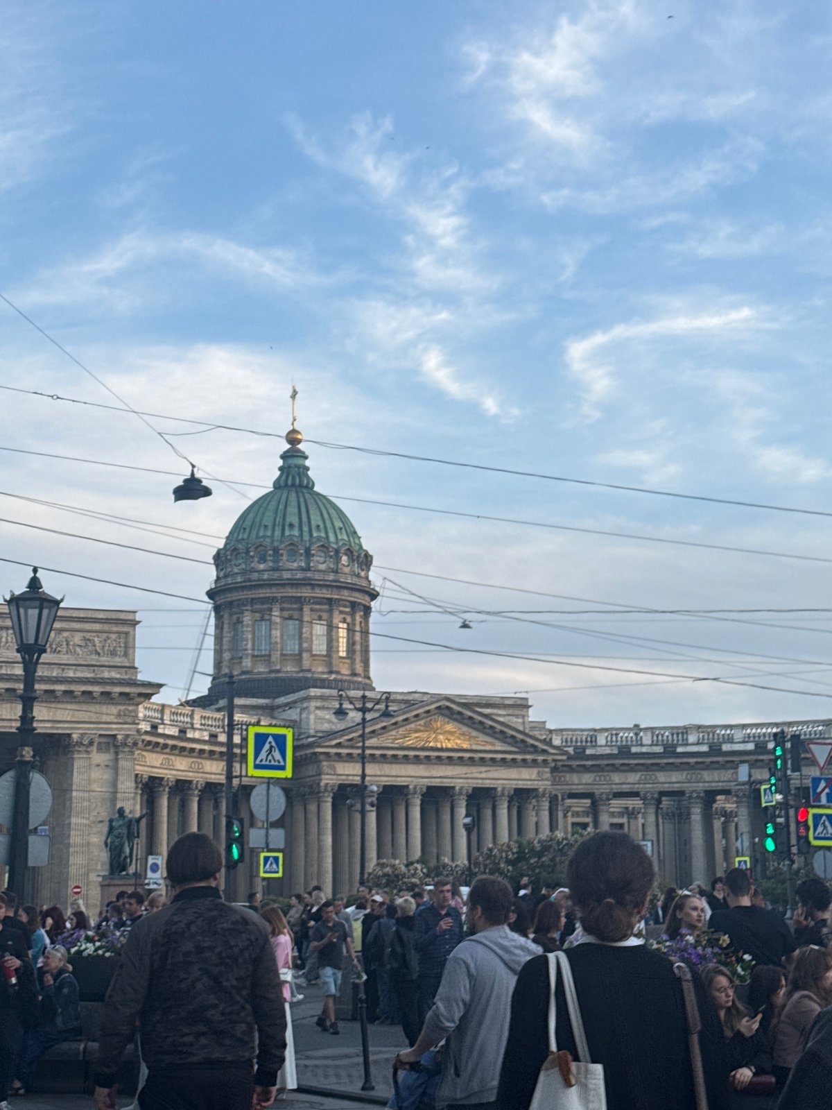 Evening street life unfolds around Saint Petersburg's historic landmarks