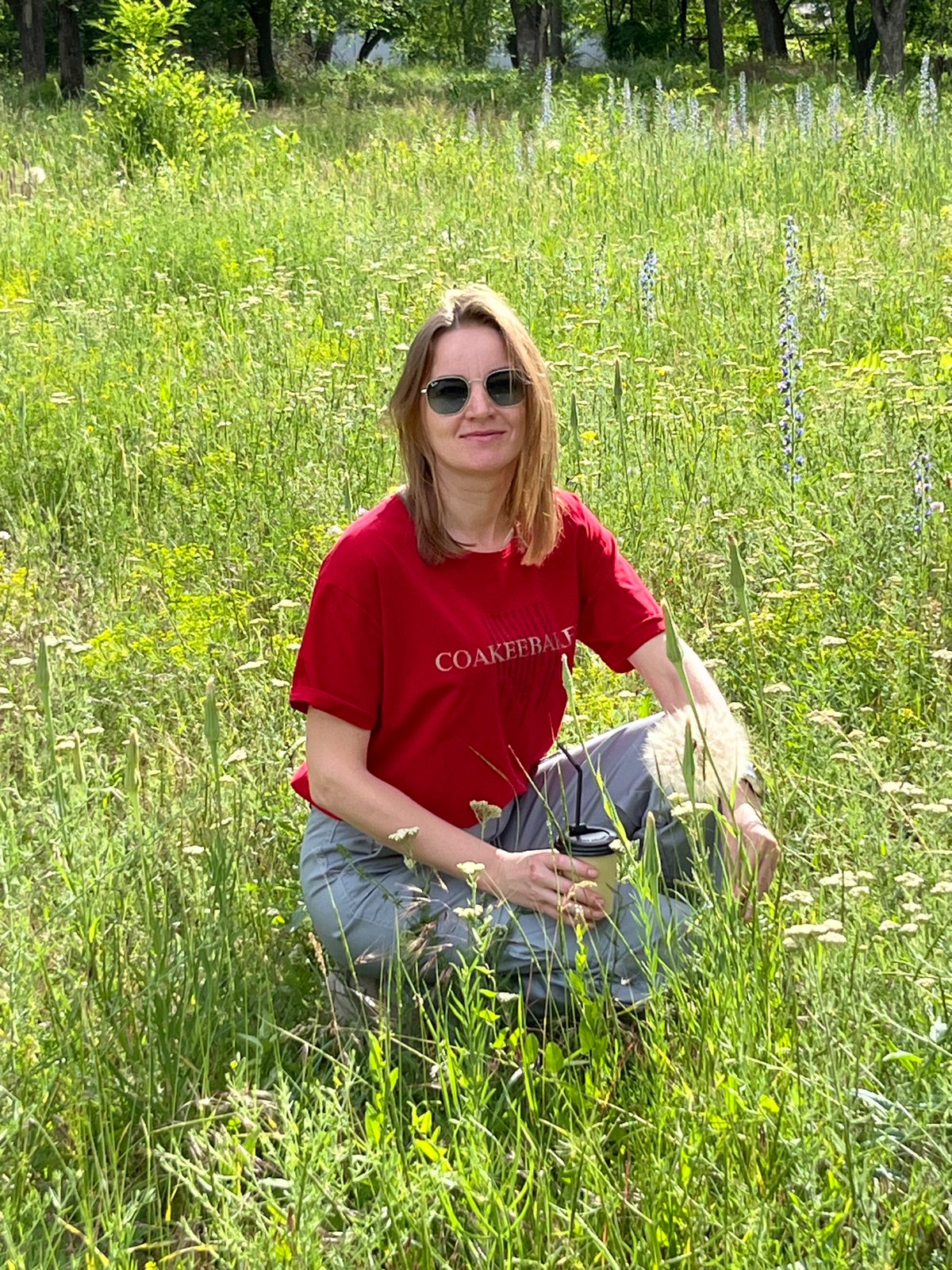 Woman enjoys coffee break in wildflower field near Kryvyi Rih