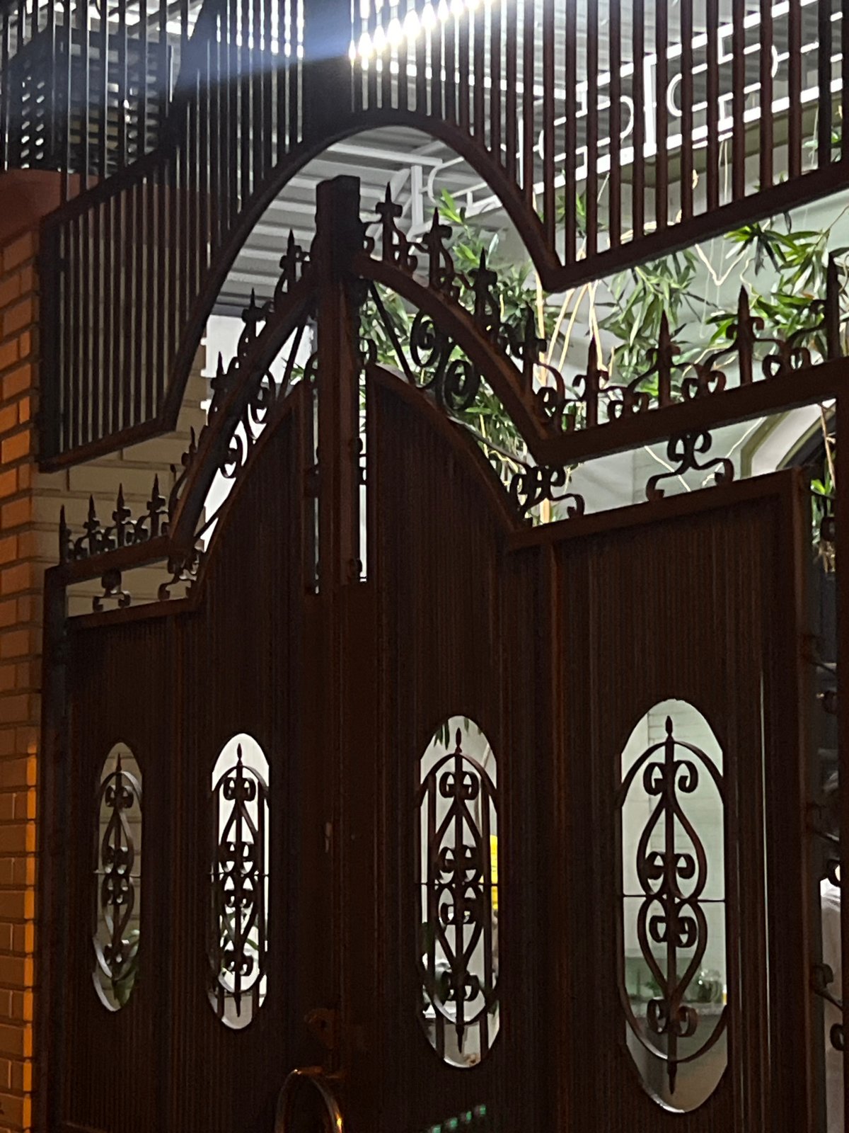 Ornate metalwork and street puddle documented in Nha Trang