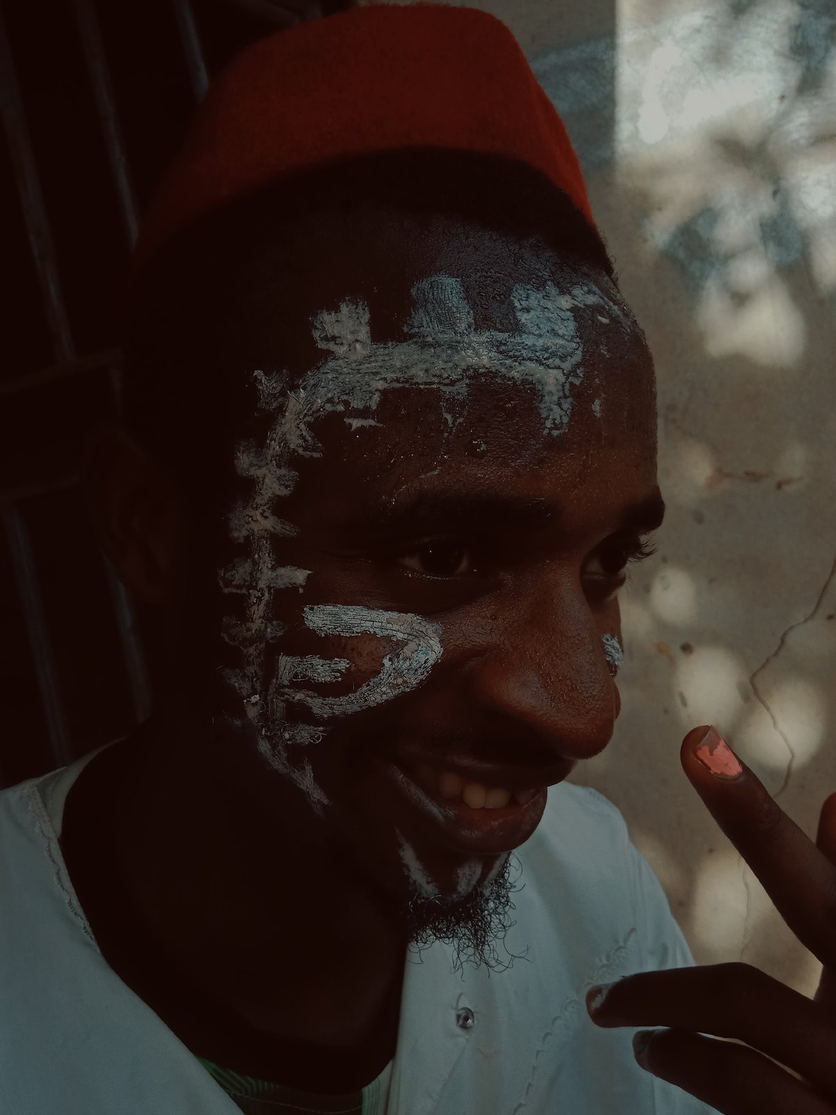 Cultural gathering features face paint, robes, and nail art