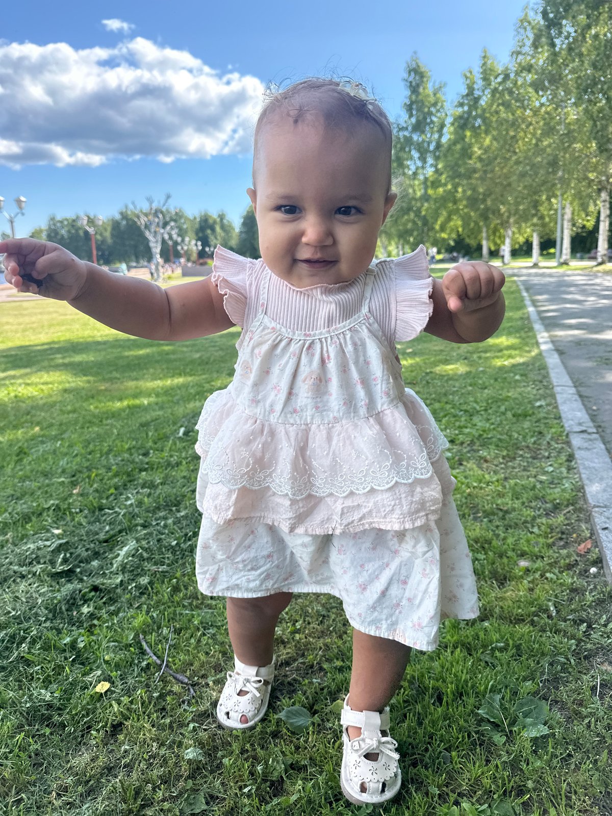 Toddler explores a Petrozavodsk park on a summer morning