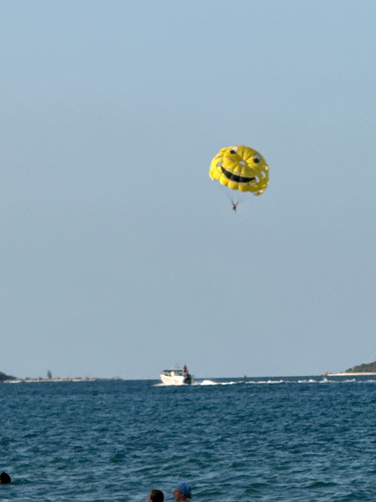 Smiley face parasail over Ko Samui's choppy coastal waters