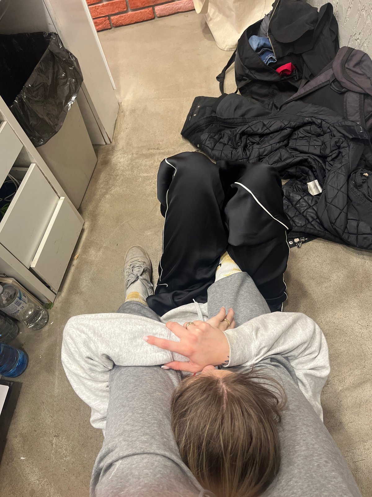 Person rests on floor indoors in Sofia