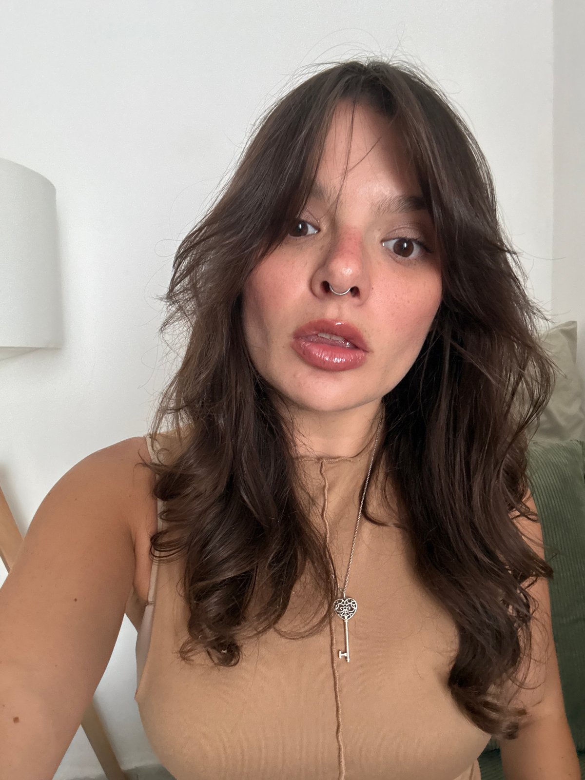 Woman takes multiple selfies indoors in Tel Aviv