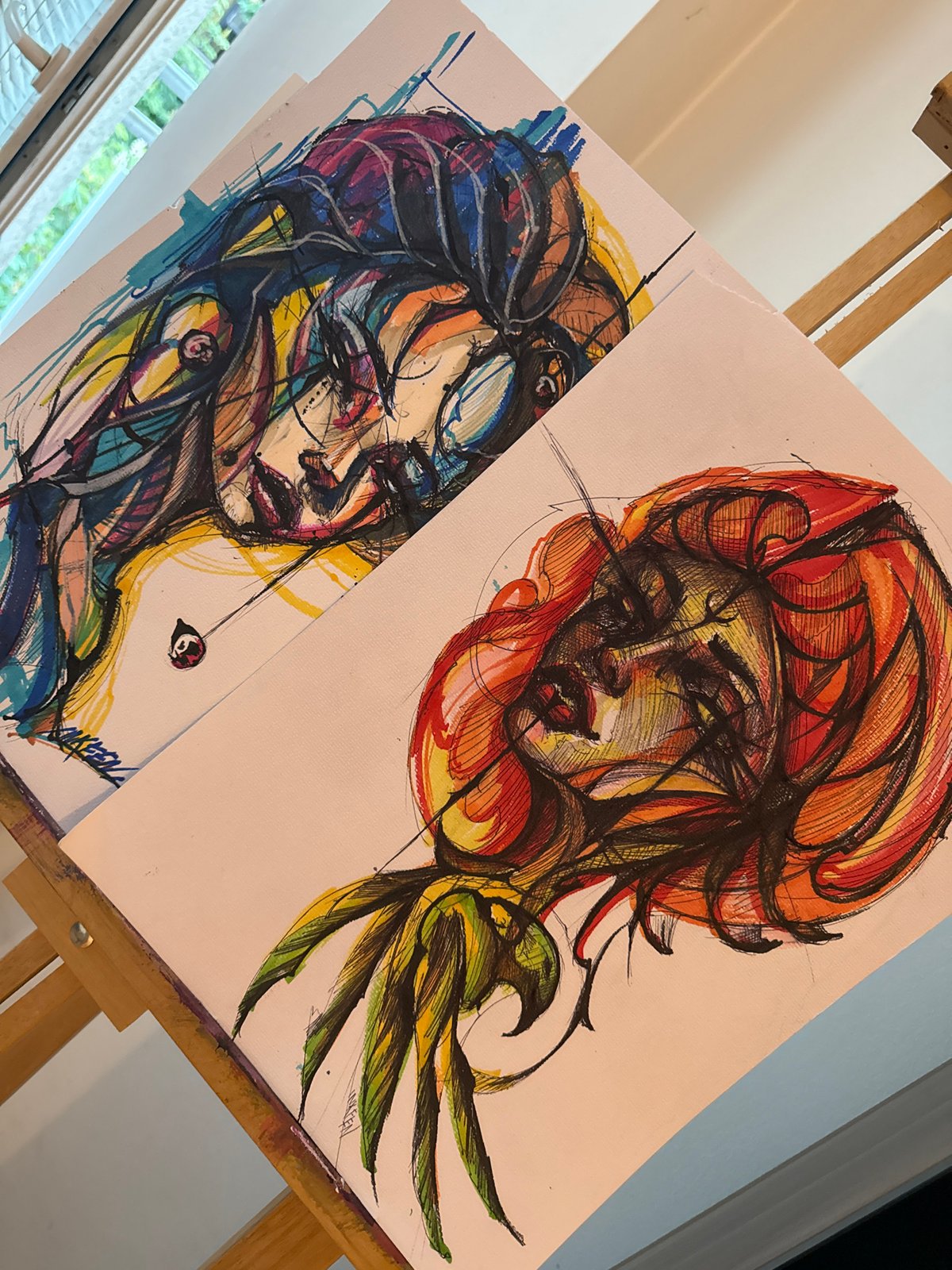 Colorful portrait drawings displayed on easel in Sofia
