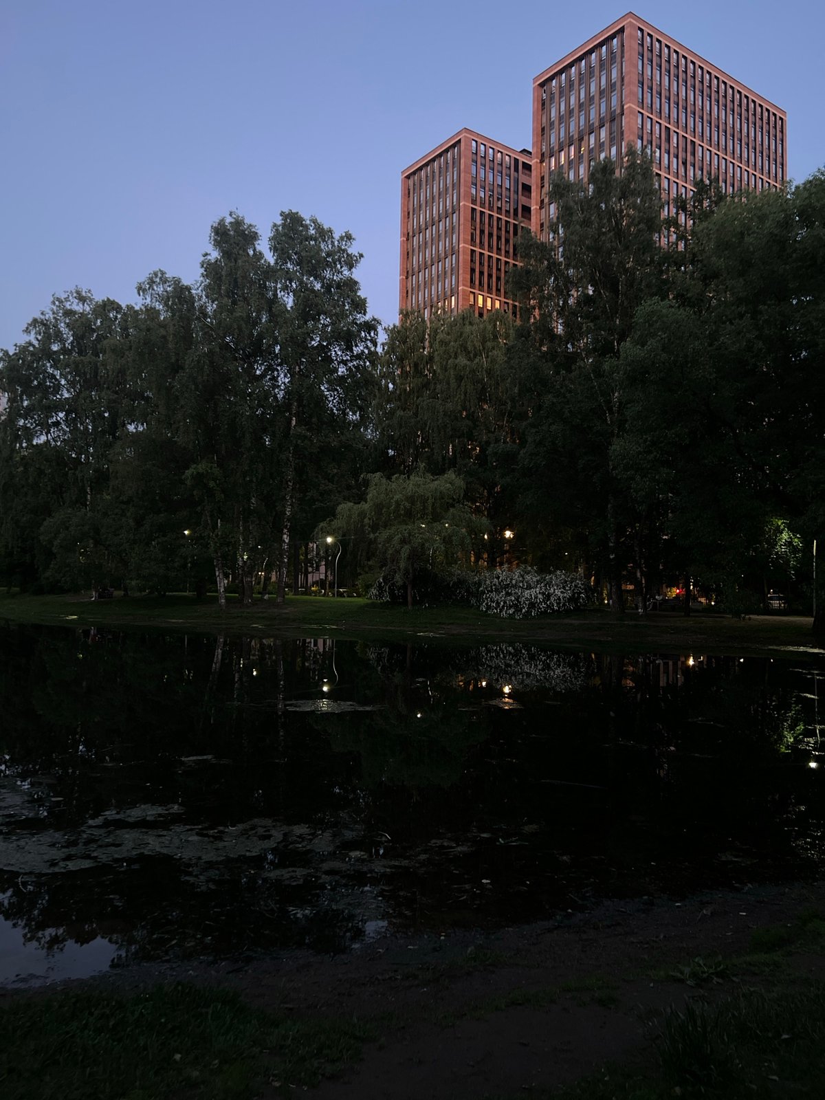 Evening park walk documented in Russian urban district