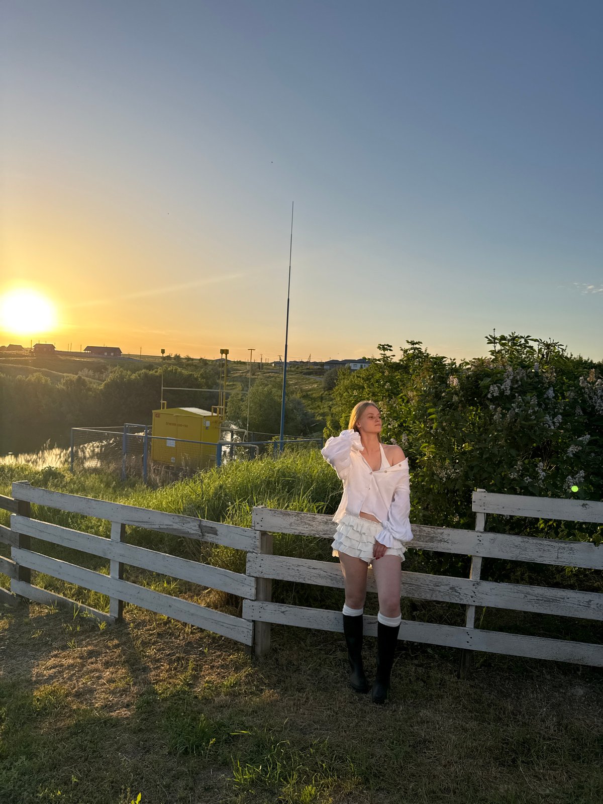 Woman poses for sunset photoshoot in rural Russian village