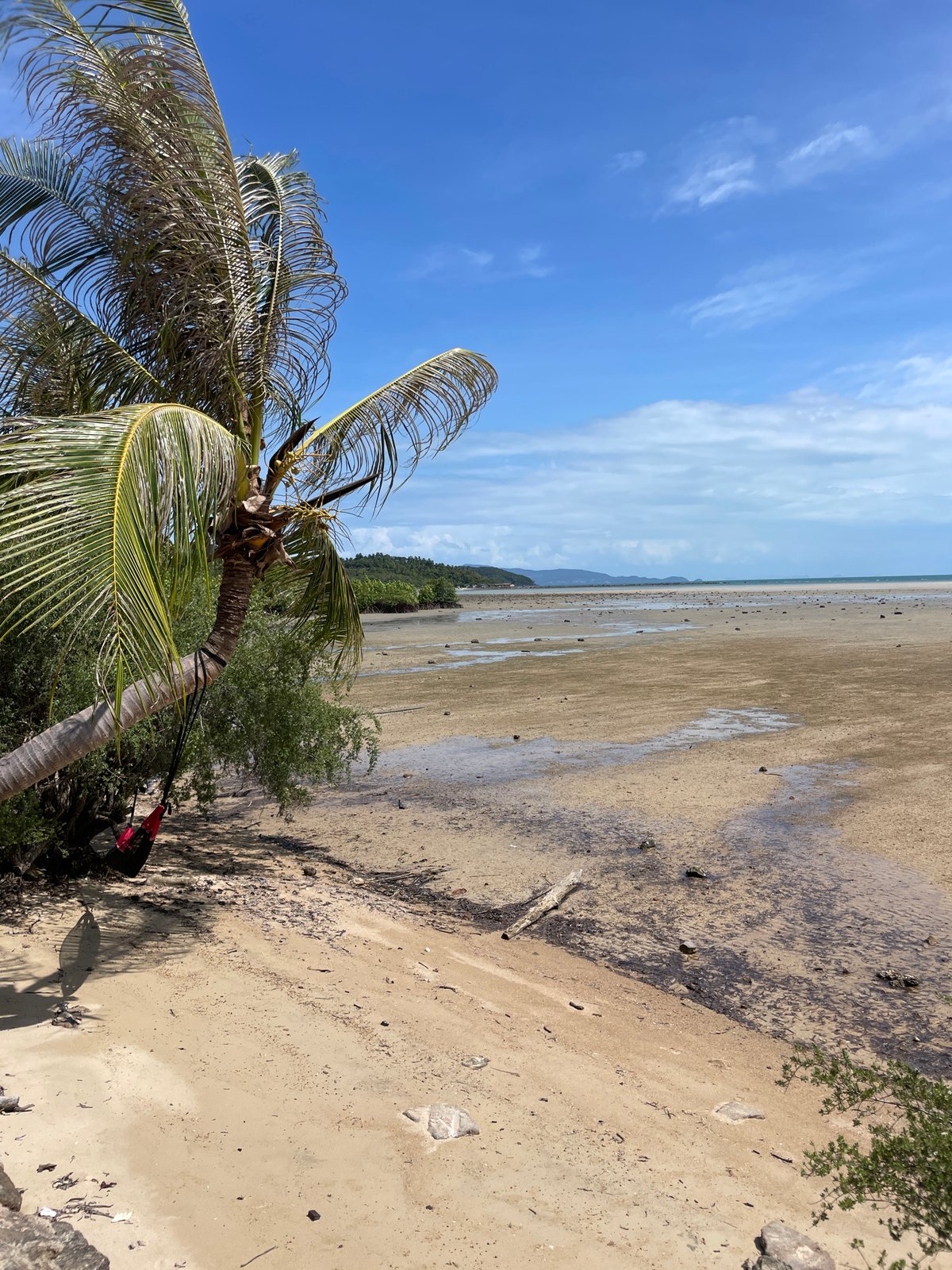 Low tide exposes wide sand flats at Thai beach