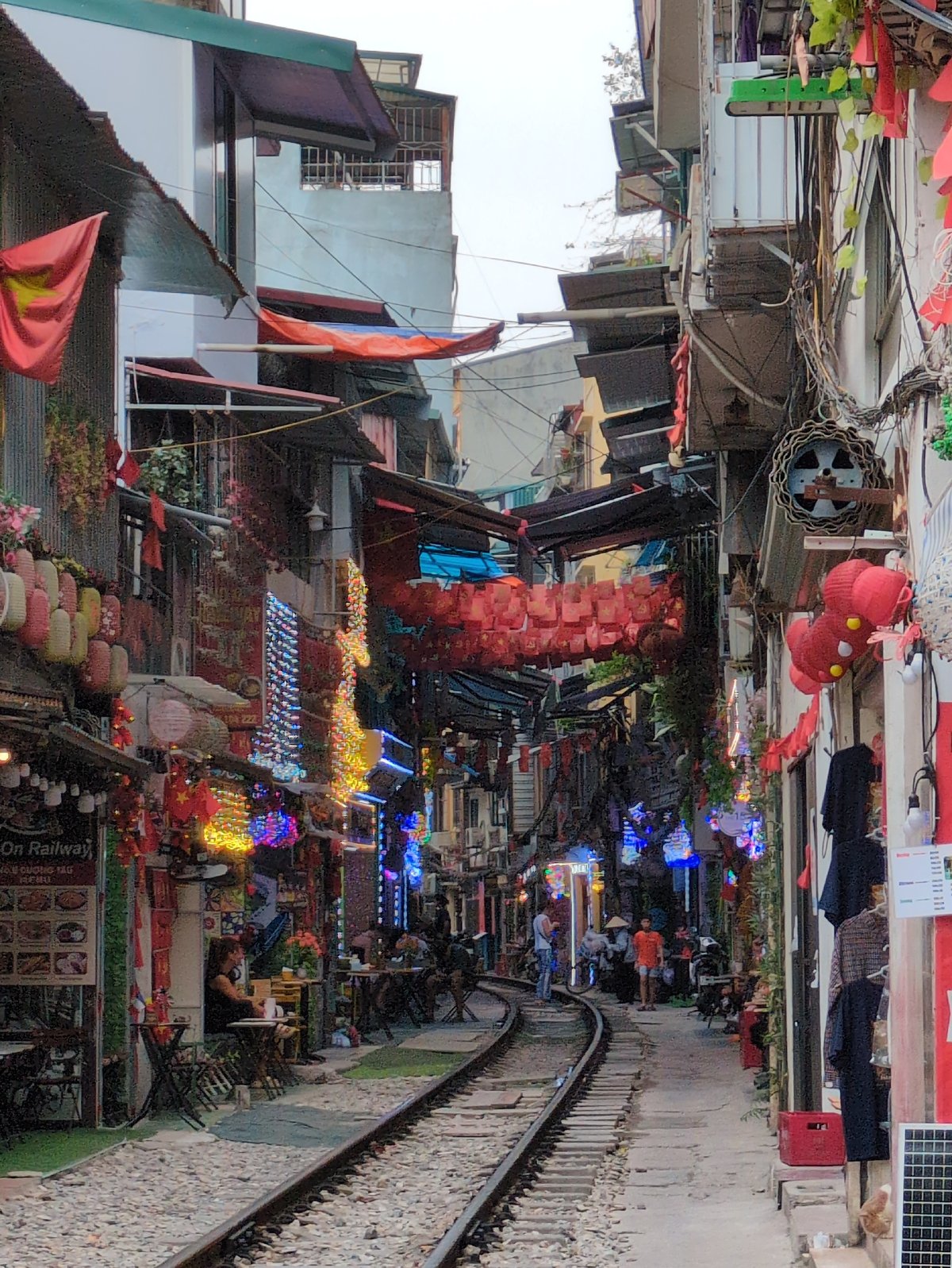 Hanoi's famous train street, tracks cutting through a busy urban corridor