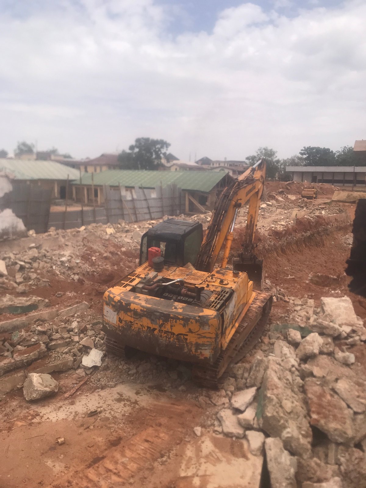 Construction work underway at Jos building site with excavator