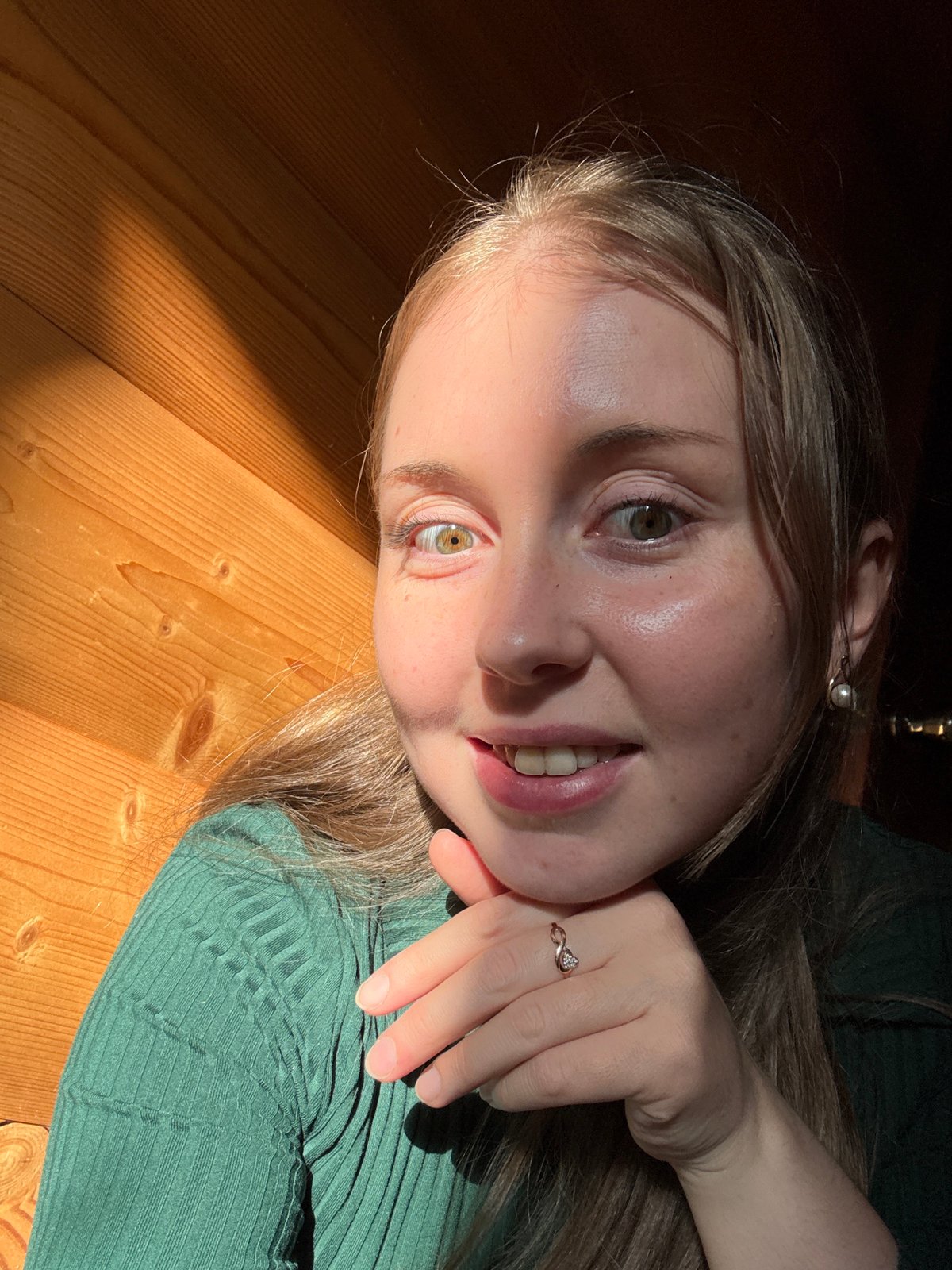 Indoor selfie session with consistent outfit and wooden backdrop