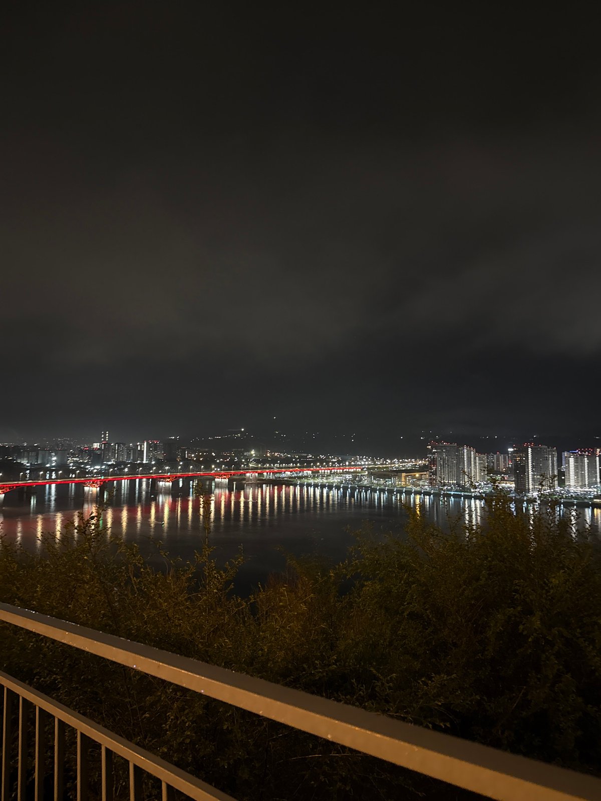 Night photography session captures illuminated Krasnoyarsk cityscape and bridge