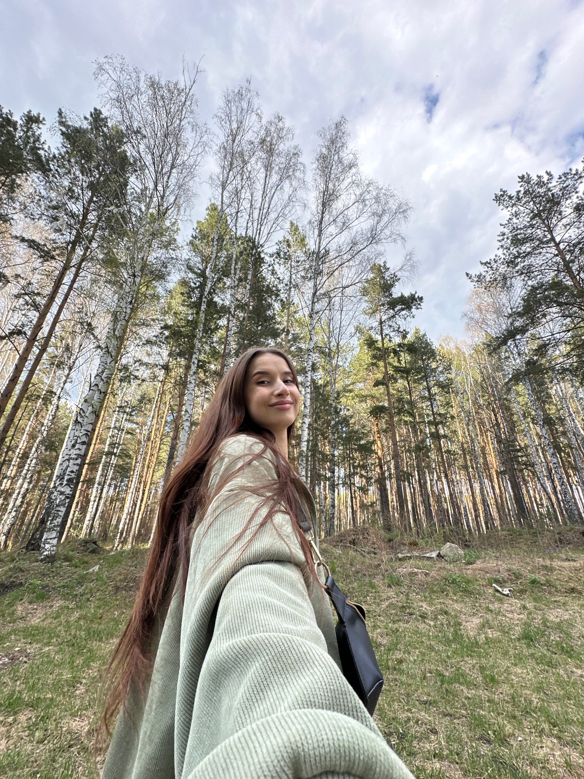Woman takes forest selfie amid birch trees in Yekaterinburg