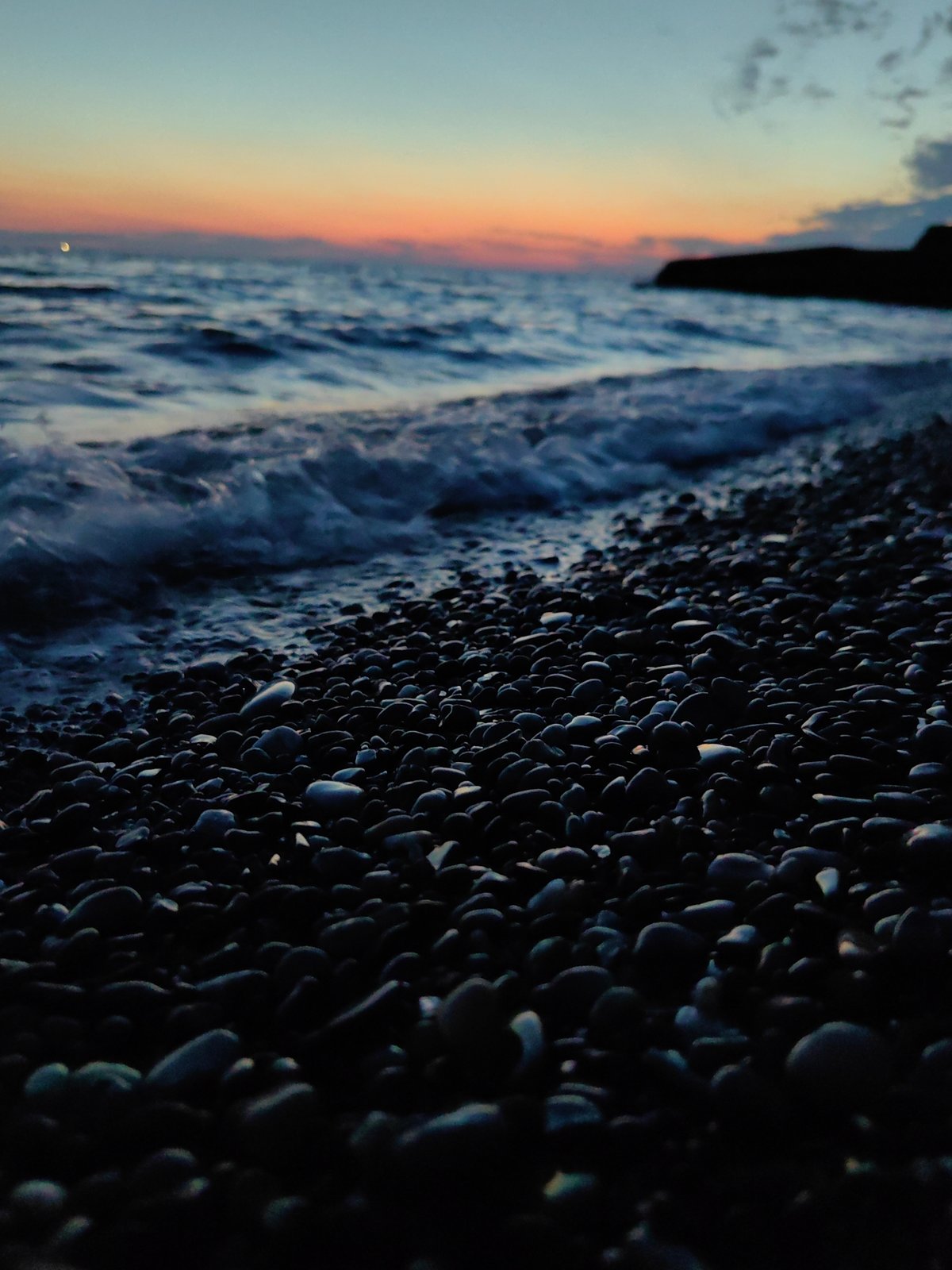 Evening stroll documented along Sochi's Black Sea coastline at dusk