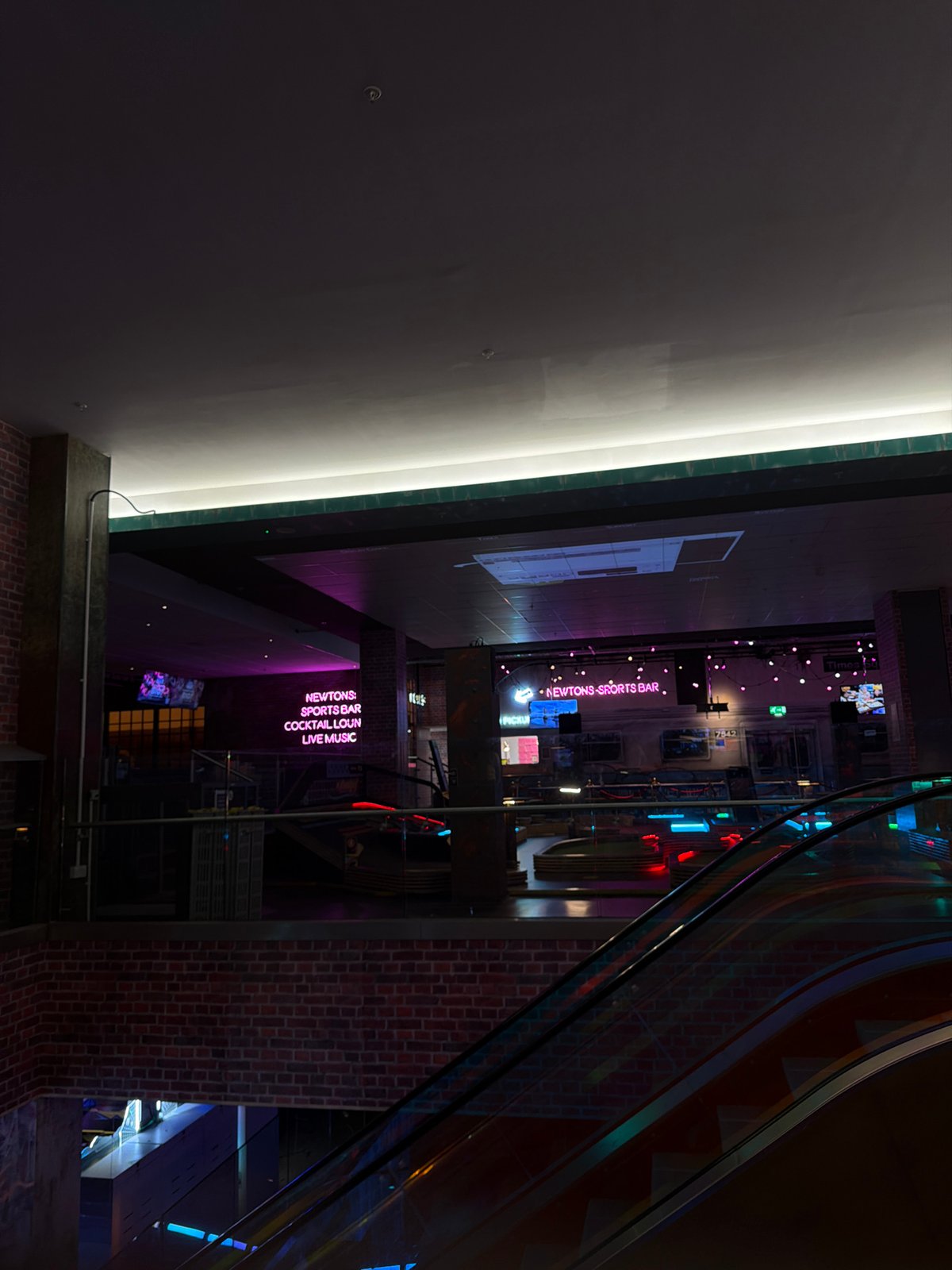Indoor entertainment venue captured in evening lighting setup