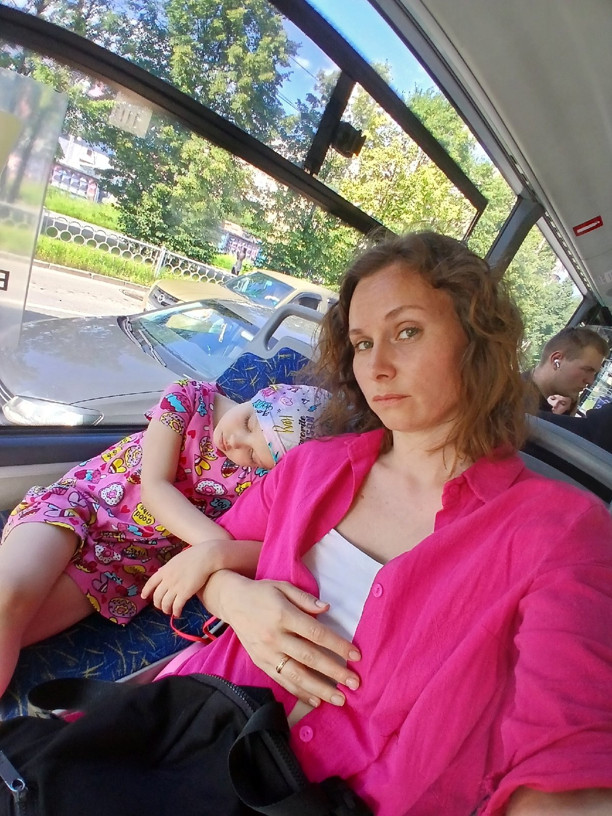 Selfie on a Yekaterinburg bus, child asleep in lap