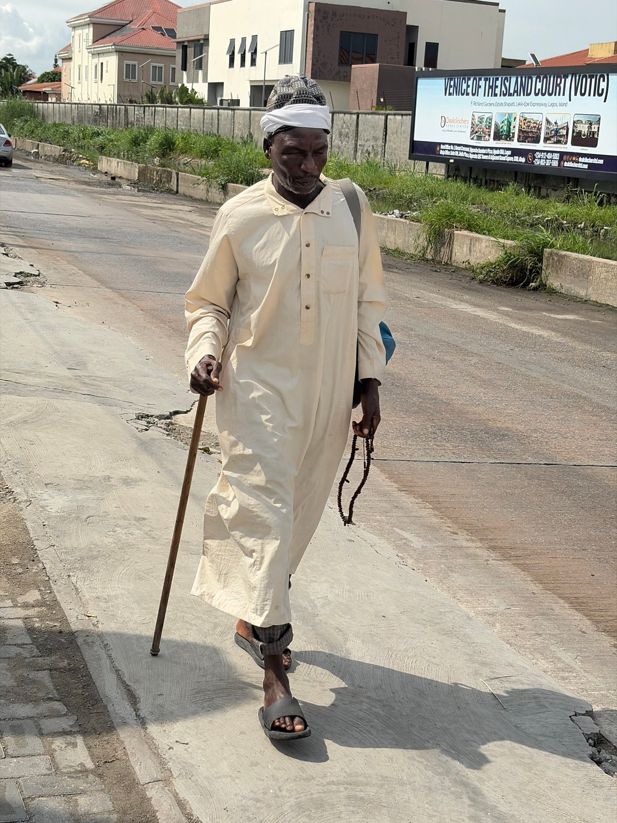 Midday street life and mixed traffic in Igboefon, Lagos