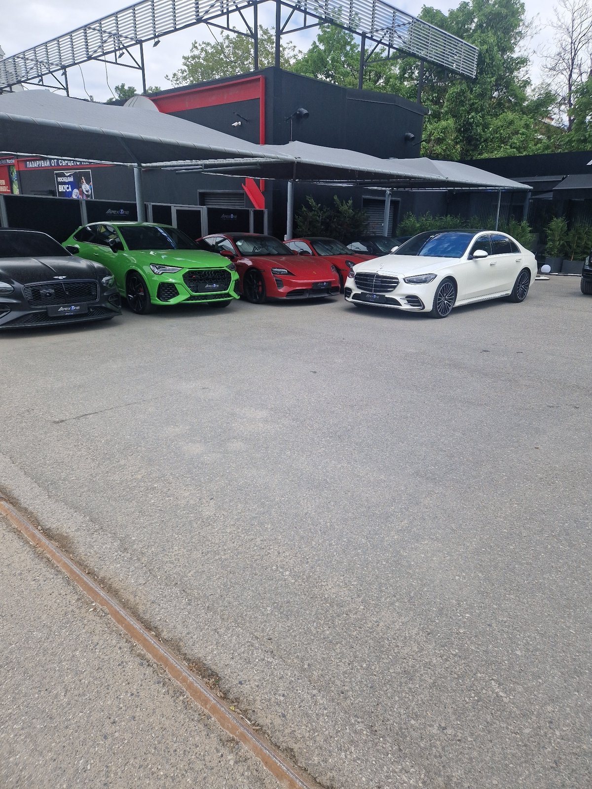 Luxury cars observed parked in urban commercial area