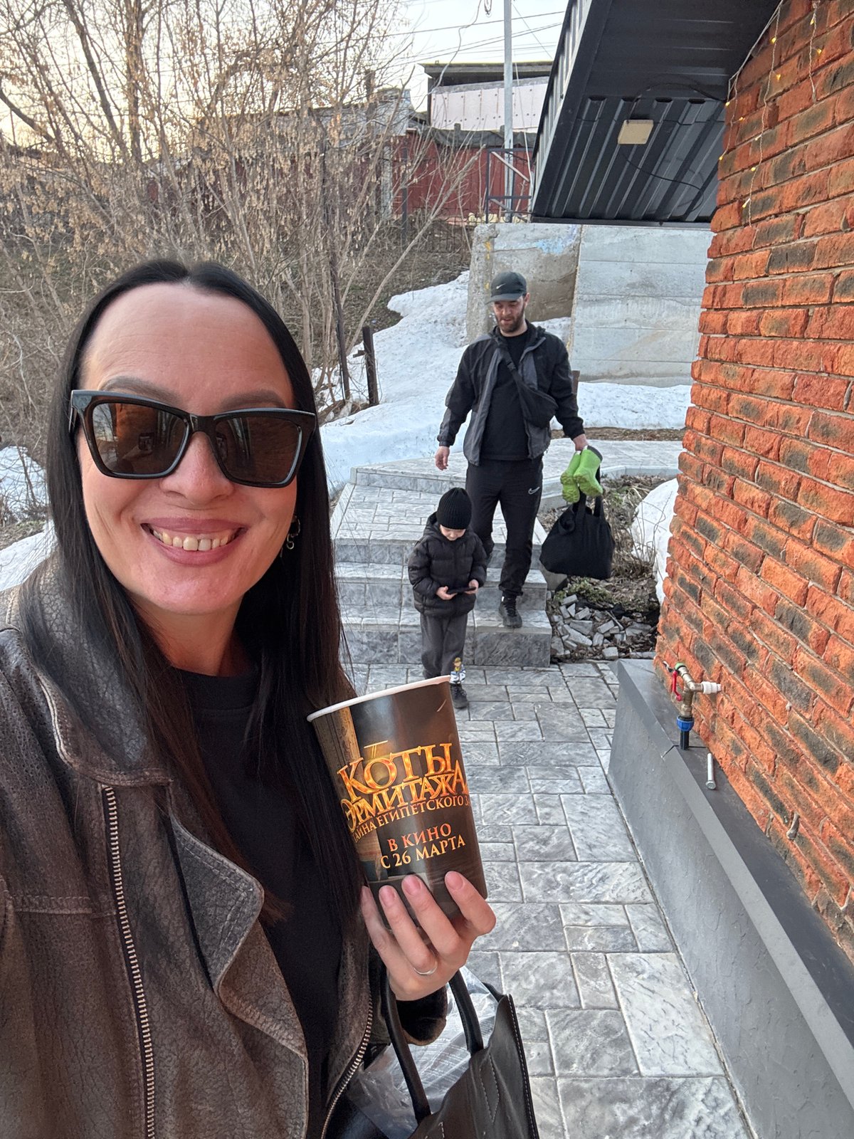Woman takes selfies with movie promo cup in Chaikovsky