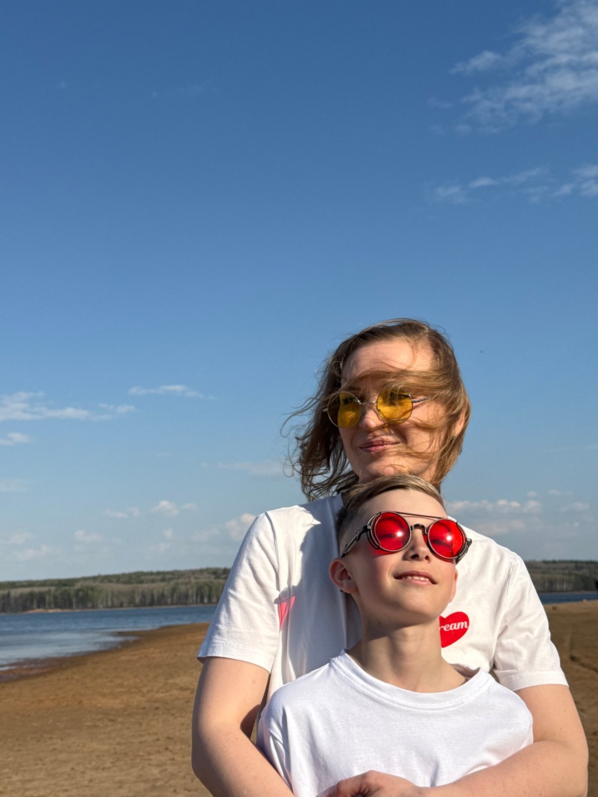 Woman and child enjoy sunny day at Chaikovsky beach