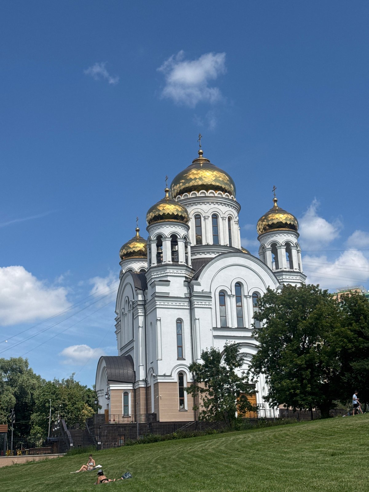 Summer afternoon near a Moscow cathedral, towel on the grass