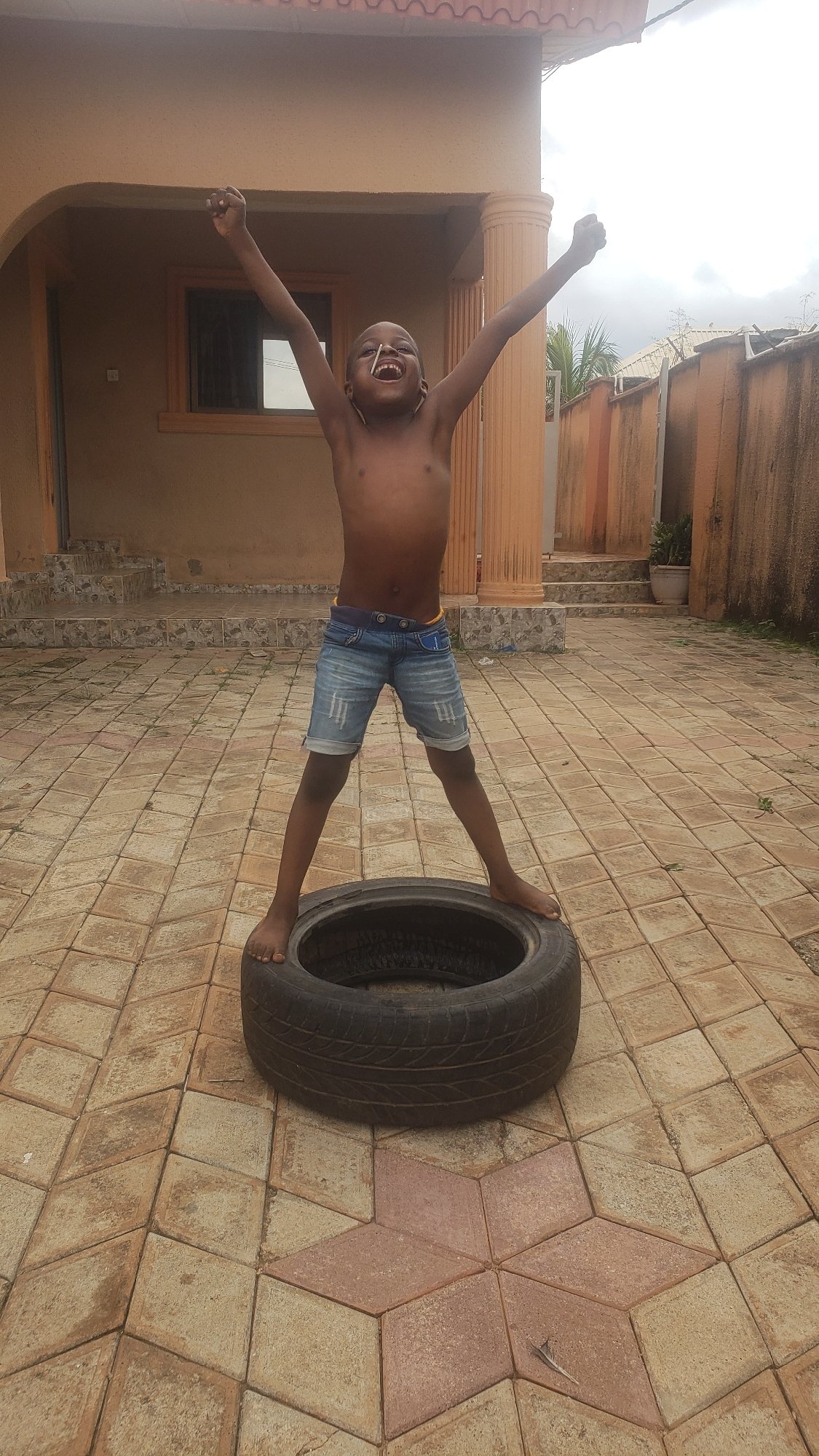 Afternoon play in a Sabon Tasha courtyard with tires and lollipops