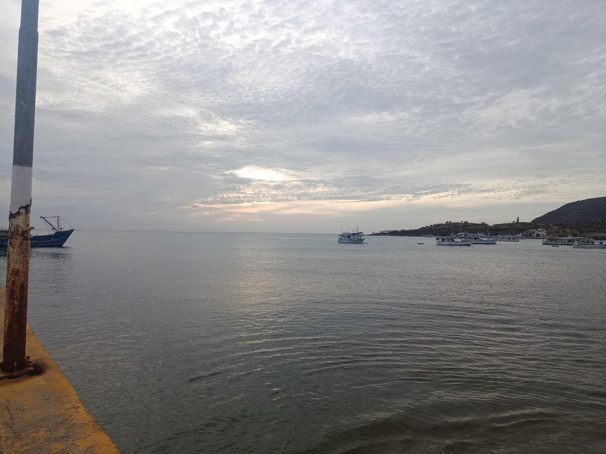 Evening documentation of Juan Griego waterfront shows boats, pedestrians