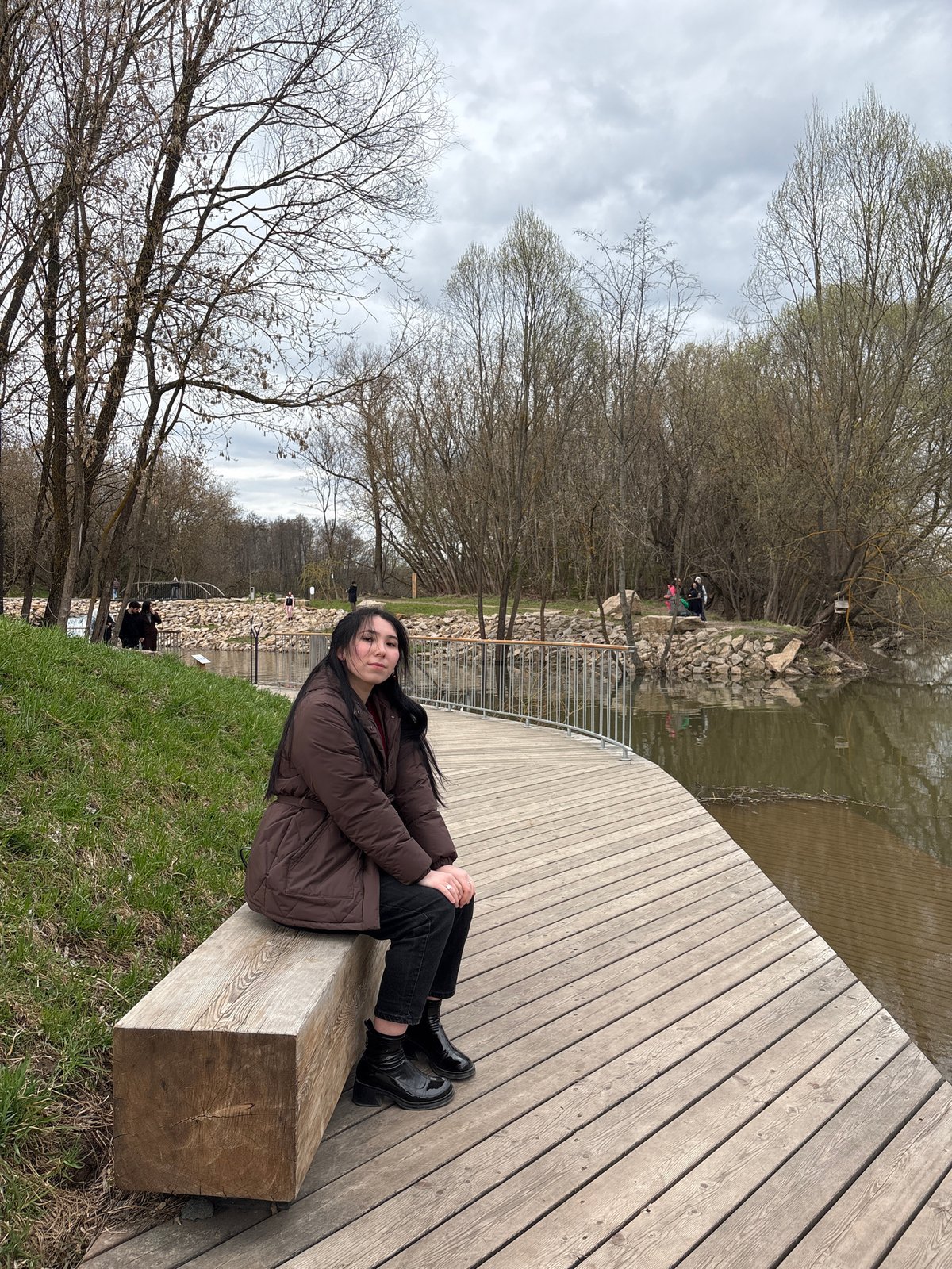 Young woman visits waterfall park in Kazan during spring