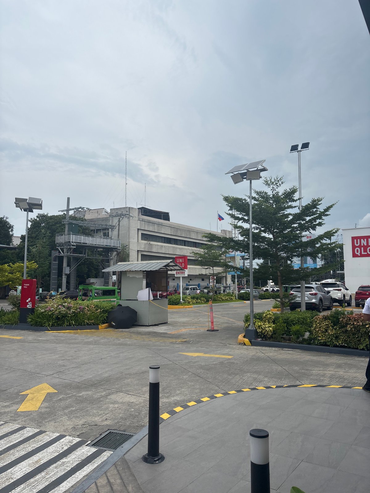 Street-level look at a Jollibee and surrounding retail strip in Davao City