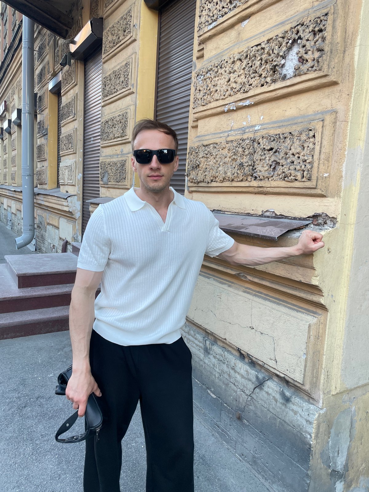 Man in white polo observed walking Saint Petersburg streets