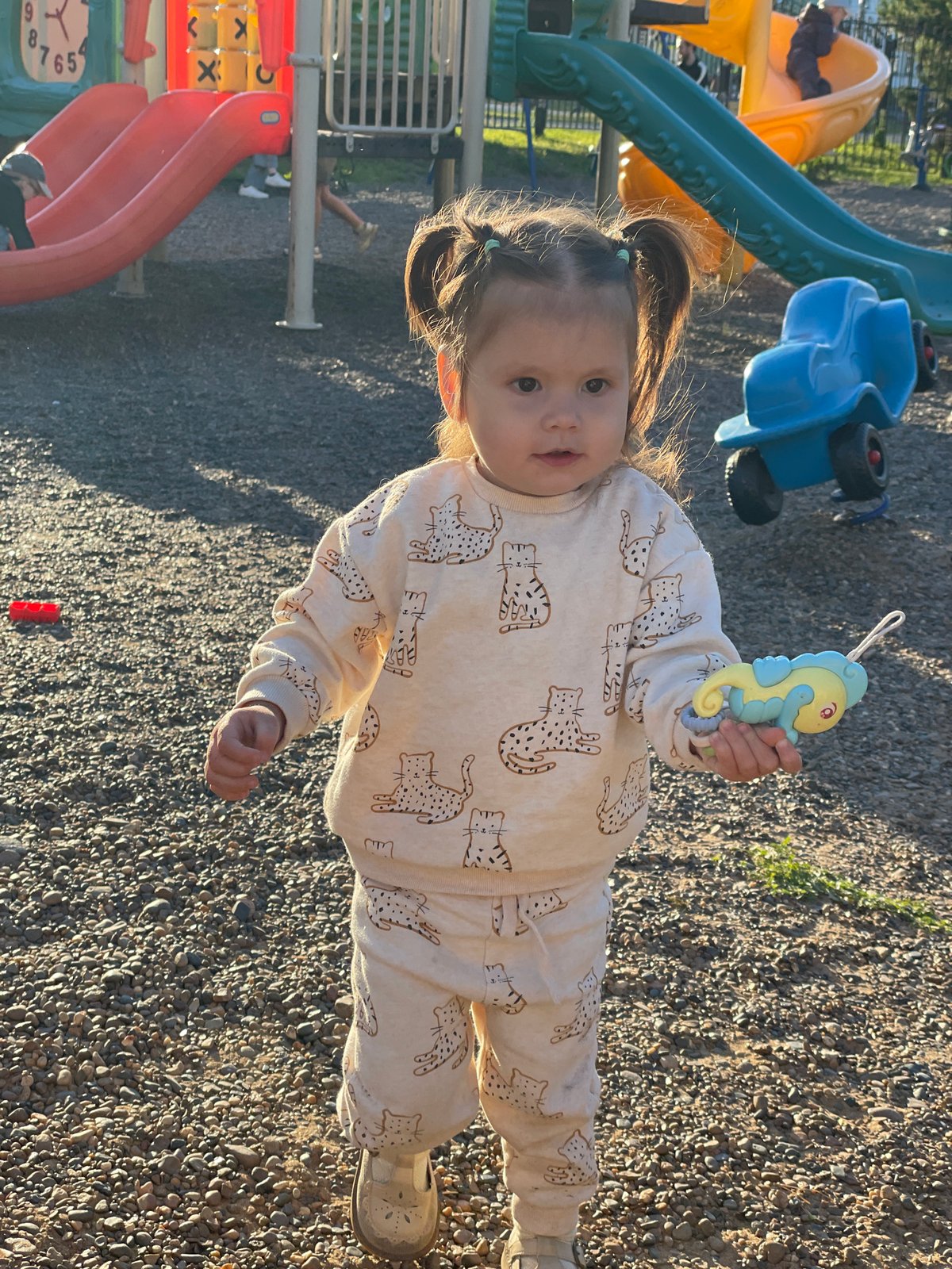 Family enjoys sunny afternoon at Izhevsk playground near cathedral
