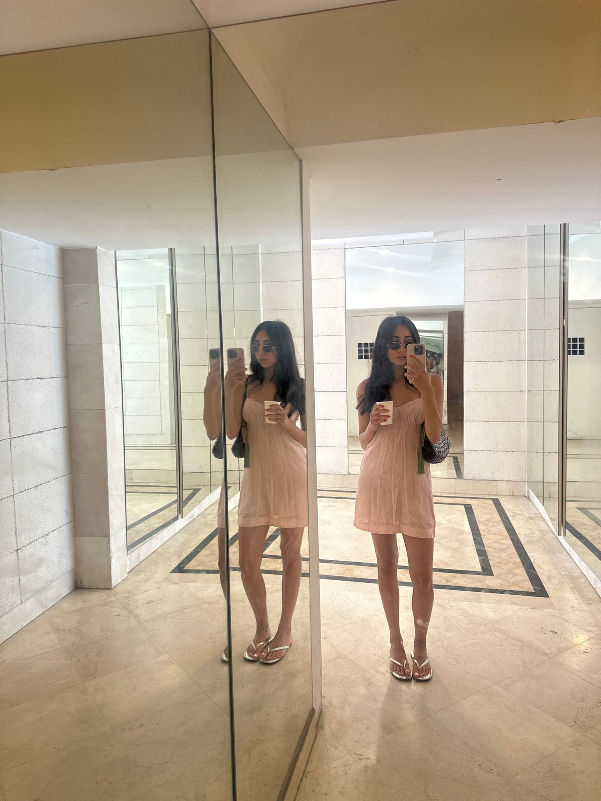 Selfies in a mirrored Tel Aviv lobby on a sunny morning