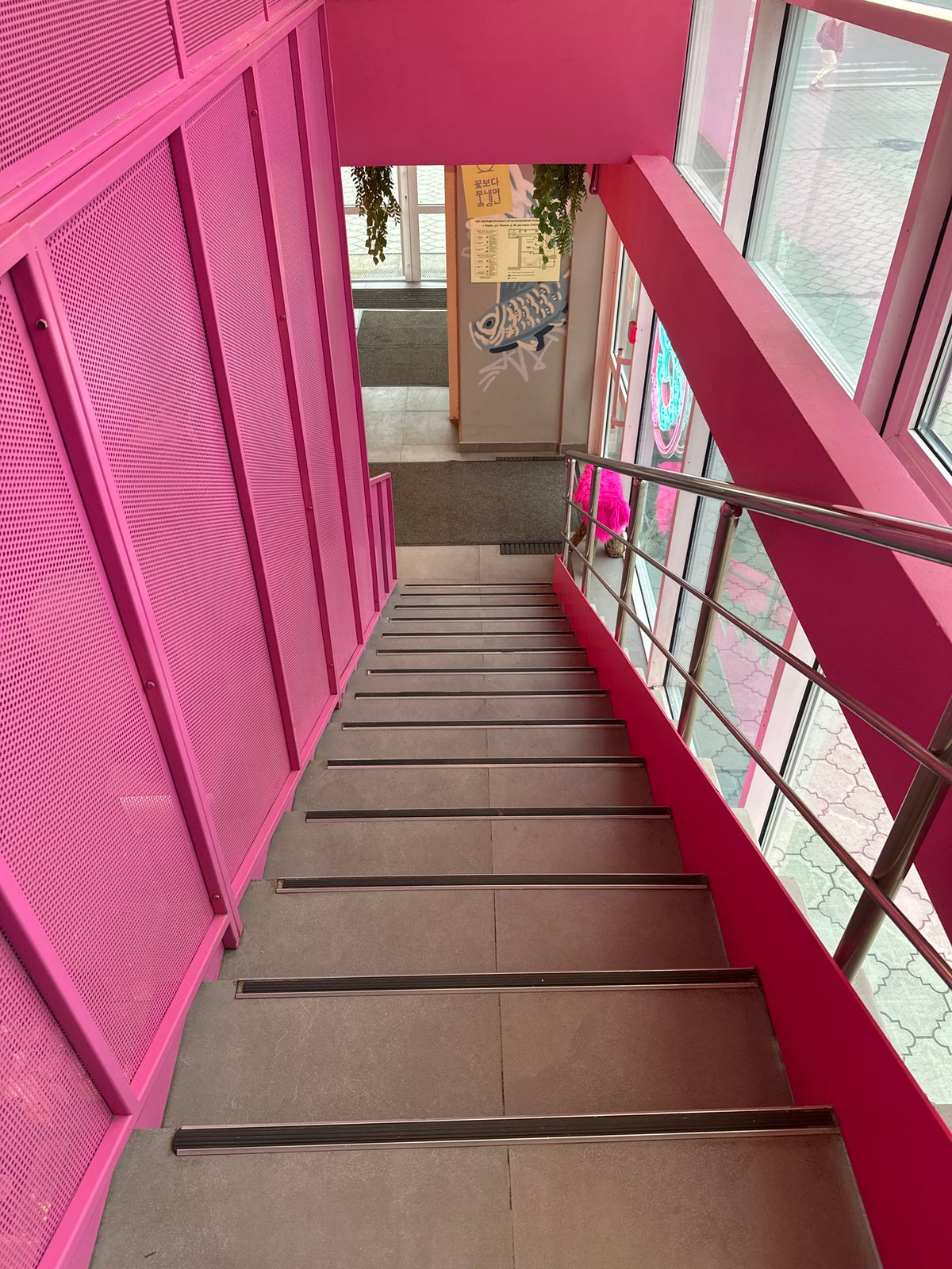Visitors document vibrant pink-themed cafe interior in Perm, Russia