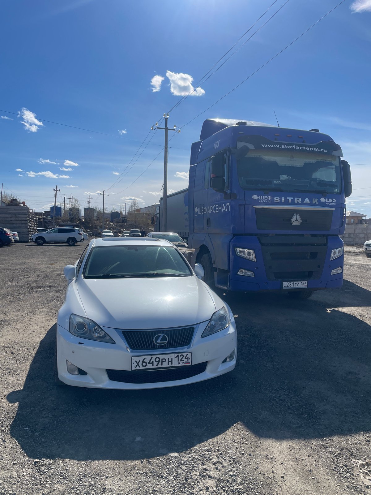 Commercial truck and Lexus parked in Krasnoyarsk lot
