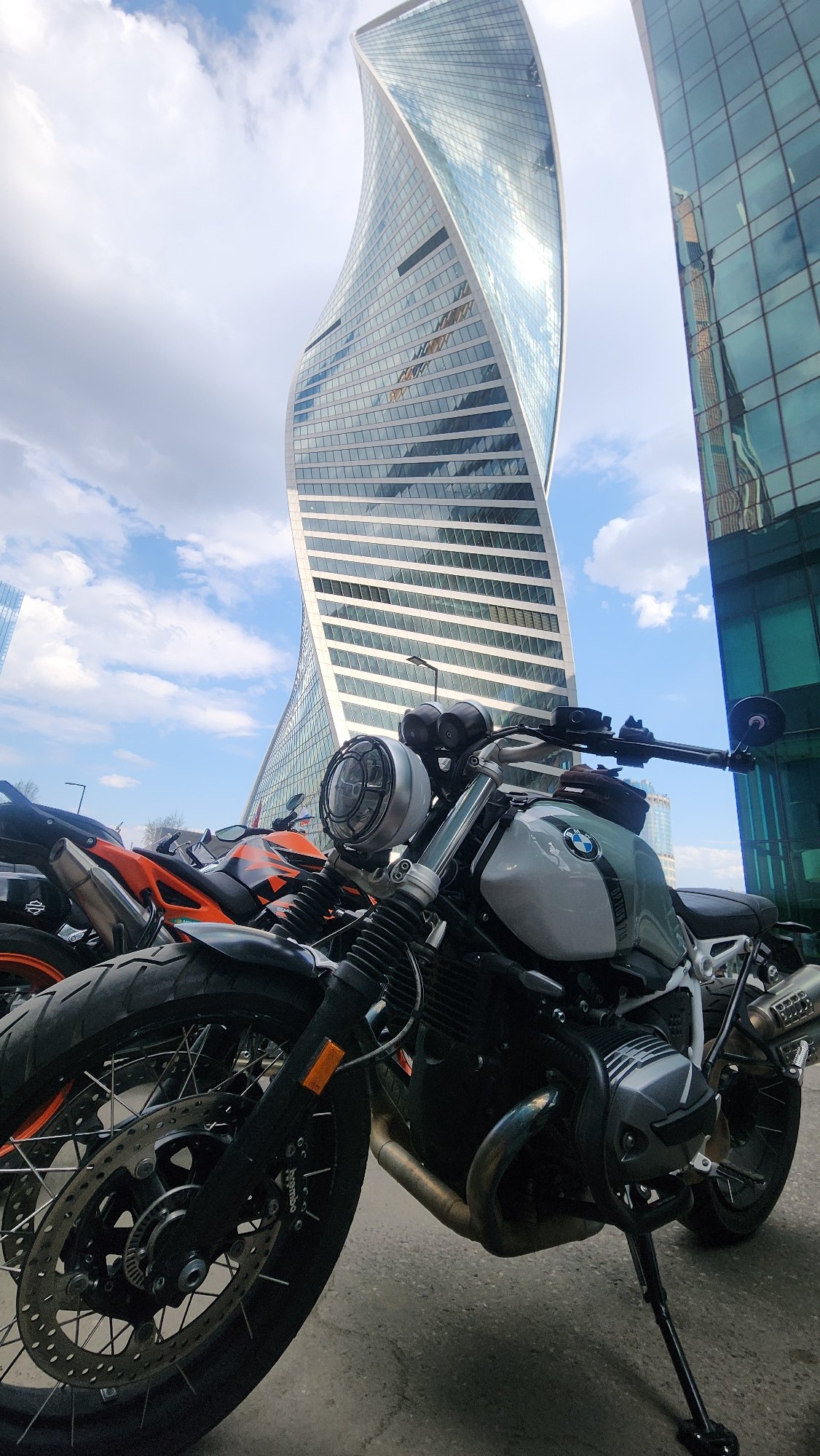 Moscow public square bustling with pedestrians, motorcycles, flying kites
