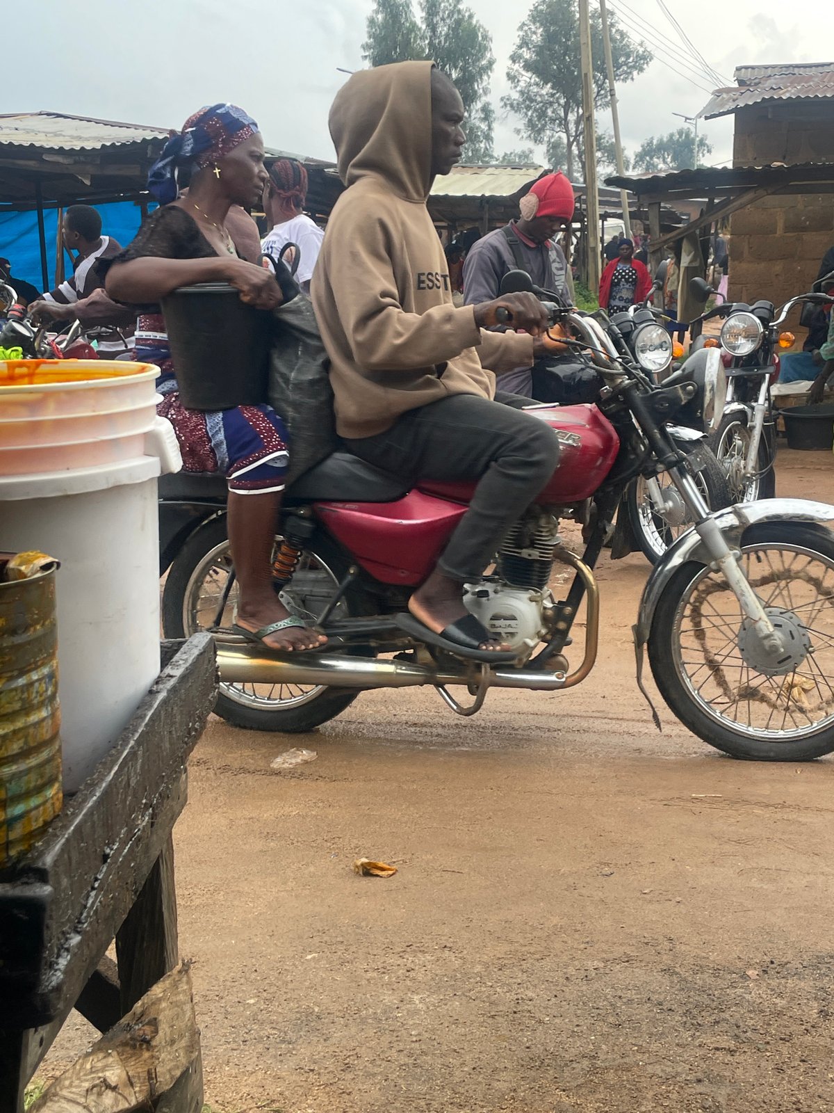 Midday market activity on wet streets in Wang, Nigeria