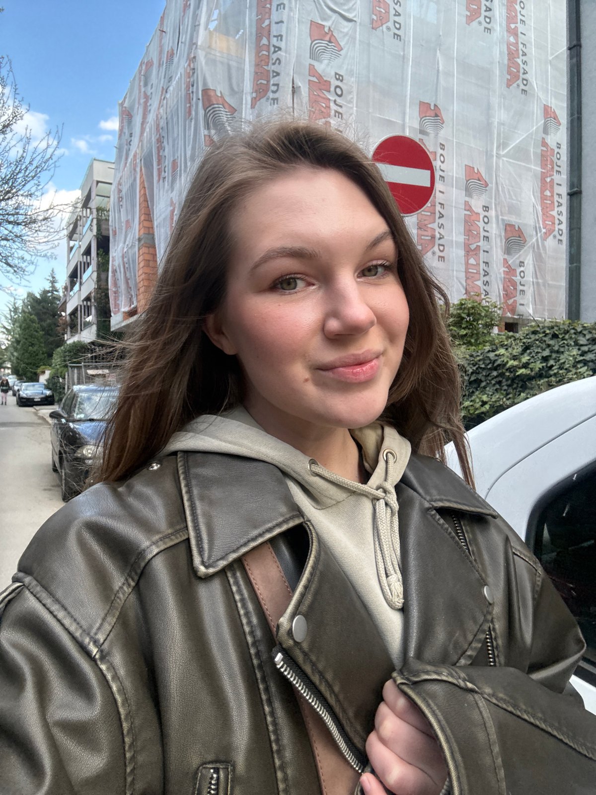 Woman takes selfie in Belgrade suburb amid urban streetscape