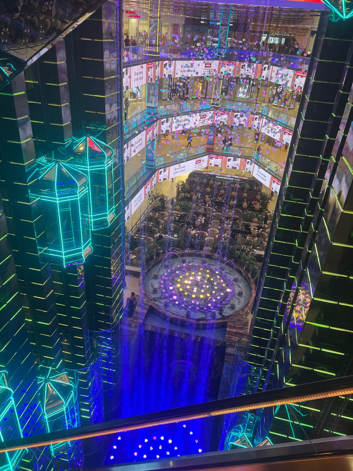 Moscow mall interior with roses, Ferris wheel documented