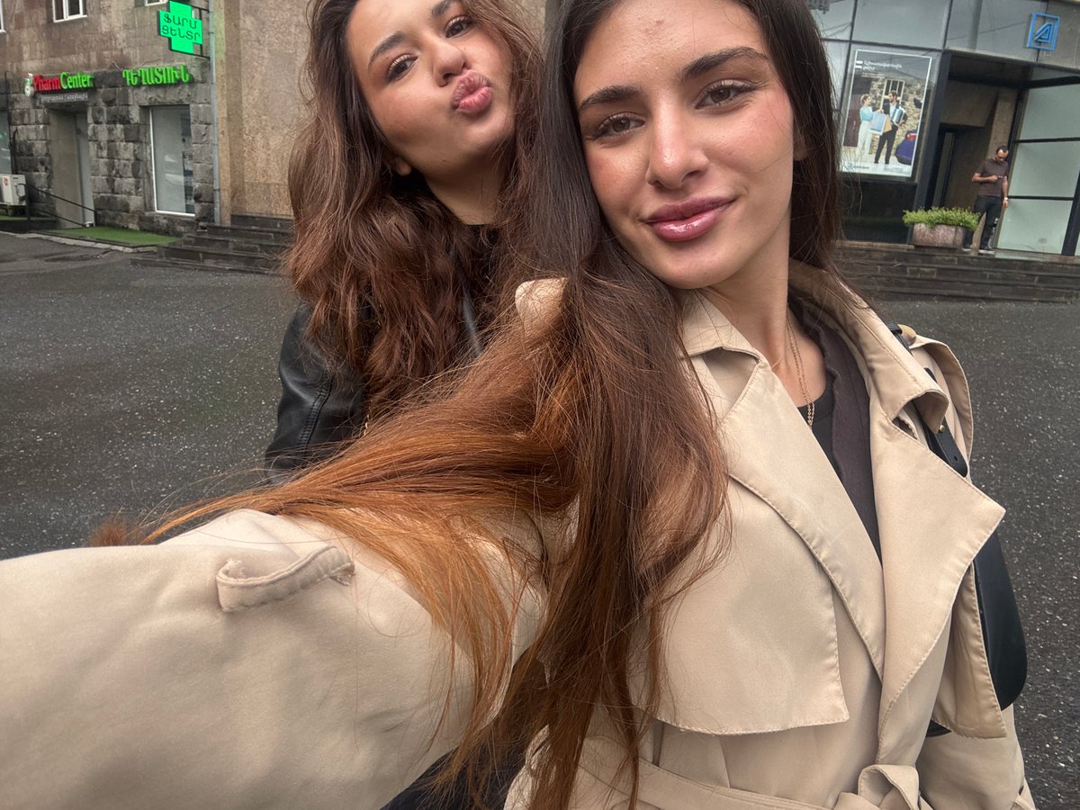 Two women photographed on rainy Yerevan street