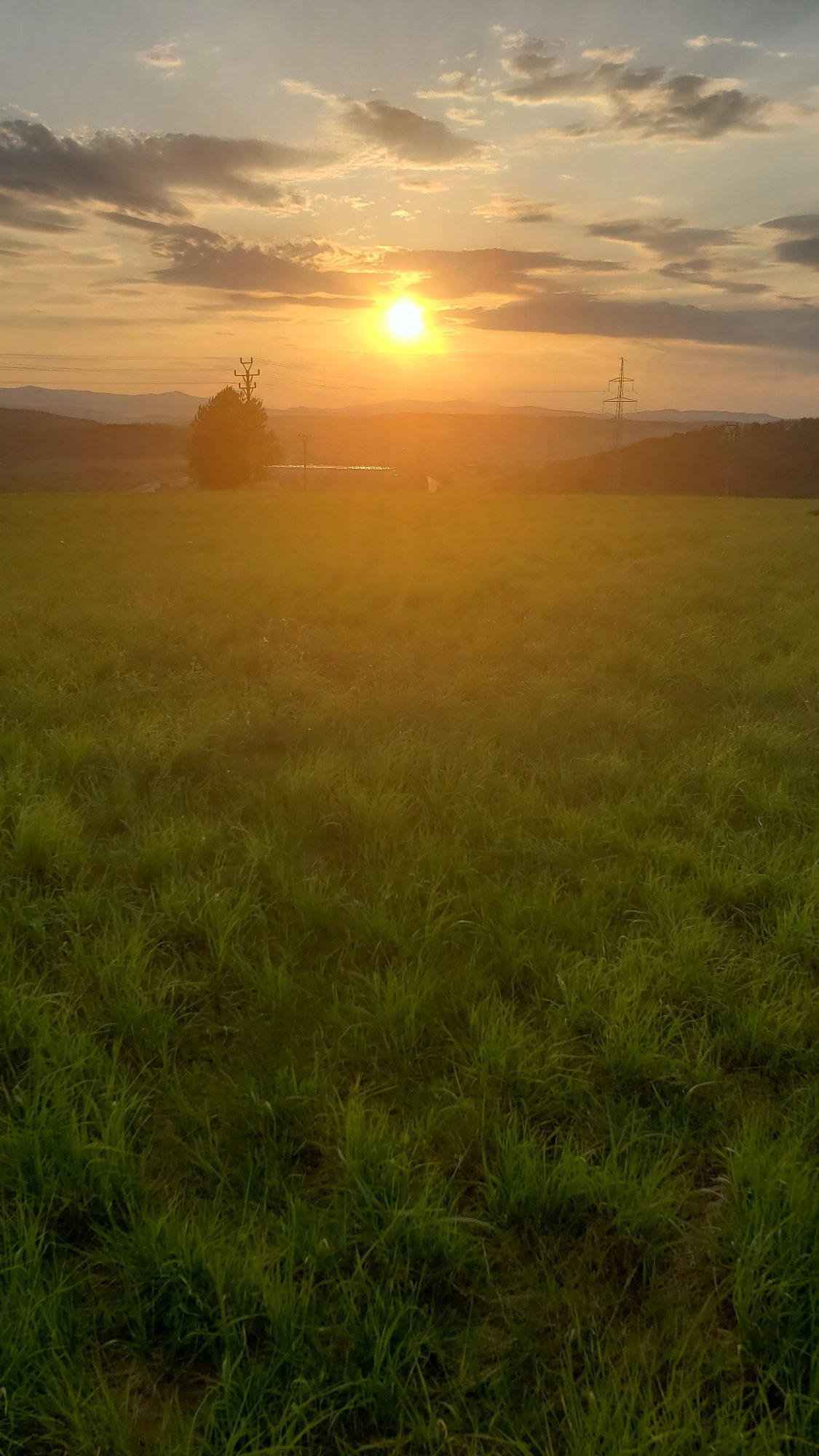 Sunset panoramas over Prešov from a grassy hilltop