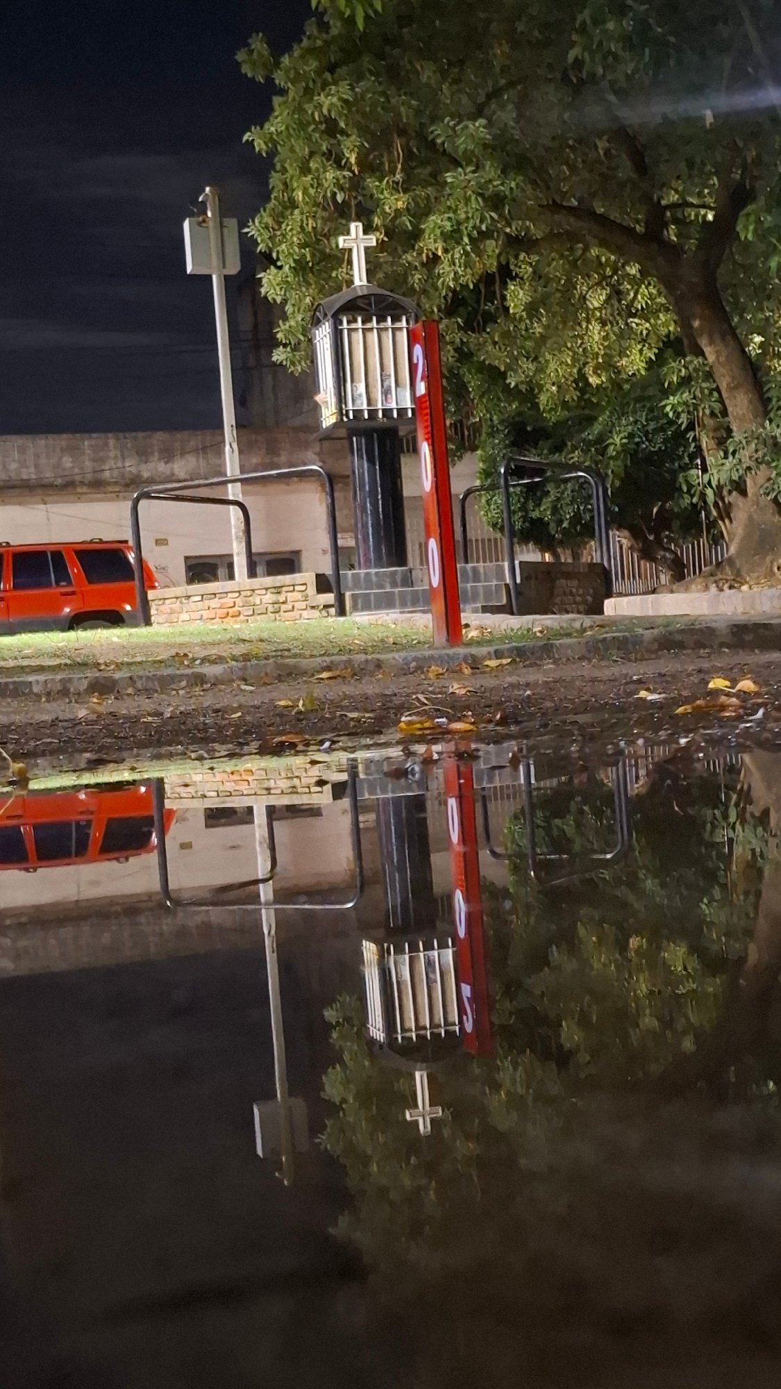 Orange-cabin ride structure spotted at night in Villa Domínico