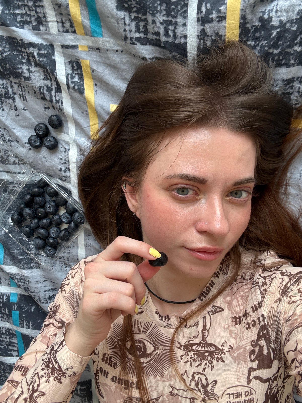 Woman enjoys blueberries at home in Moscow