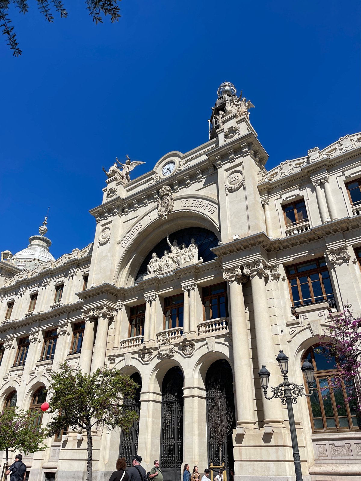 Tourist documents València's historic Correos building and city center