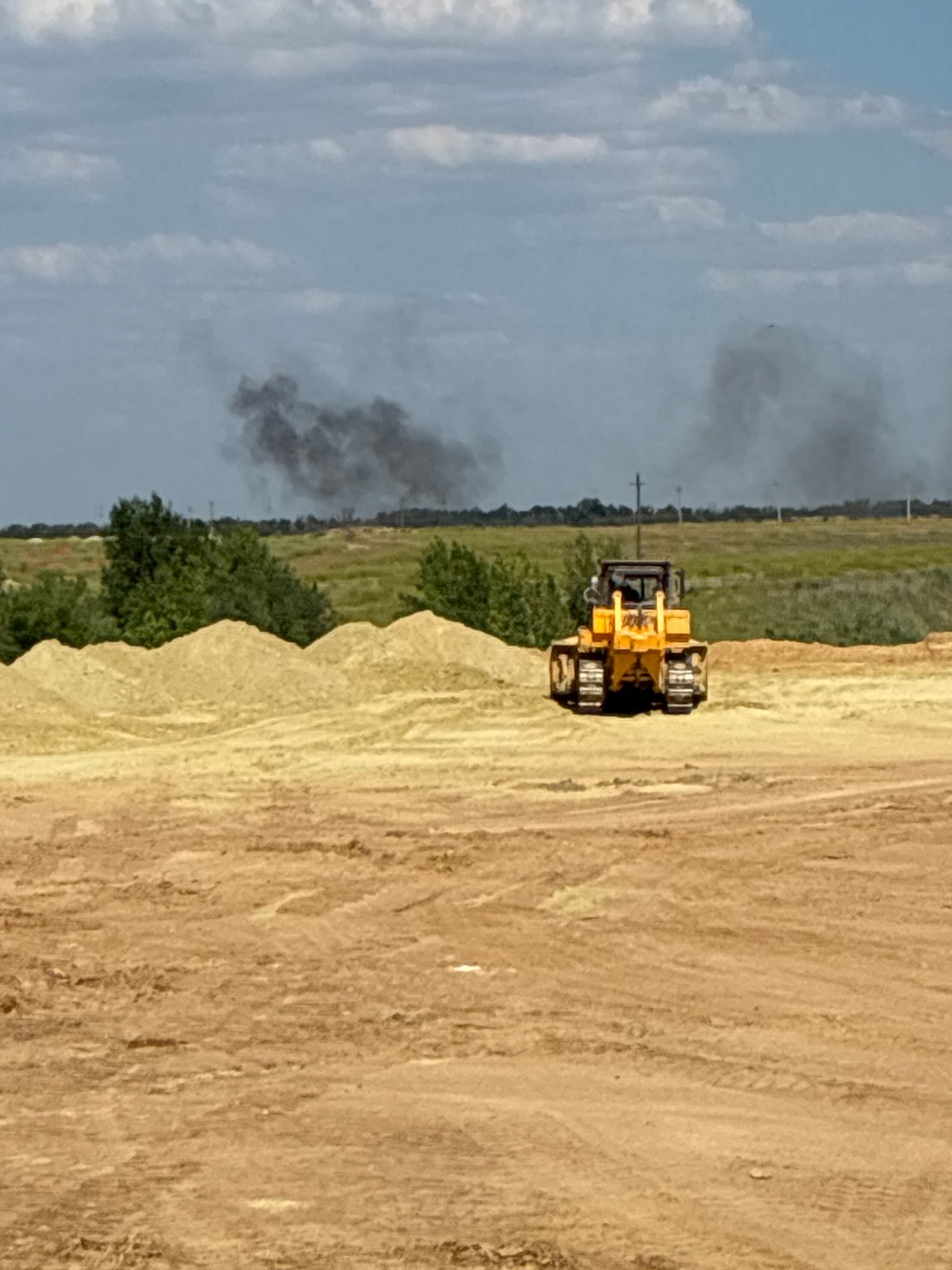 Bulldozer at work on a dusty construction site in Zhirnov