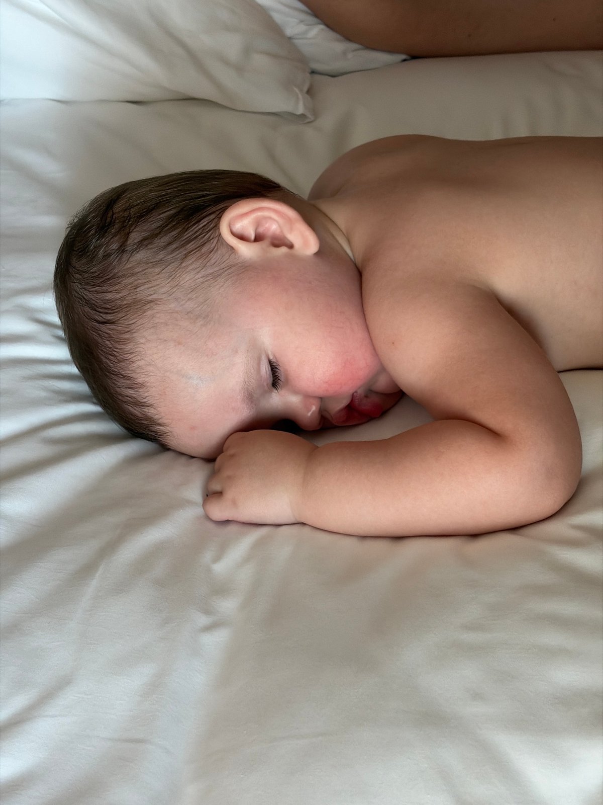 Baby observed resting on white sheet in Đà Nẵng
