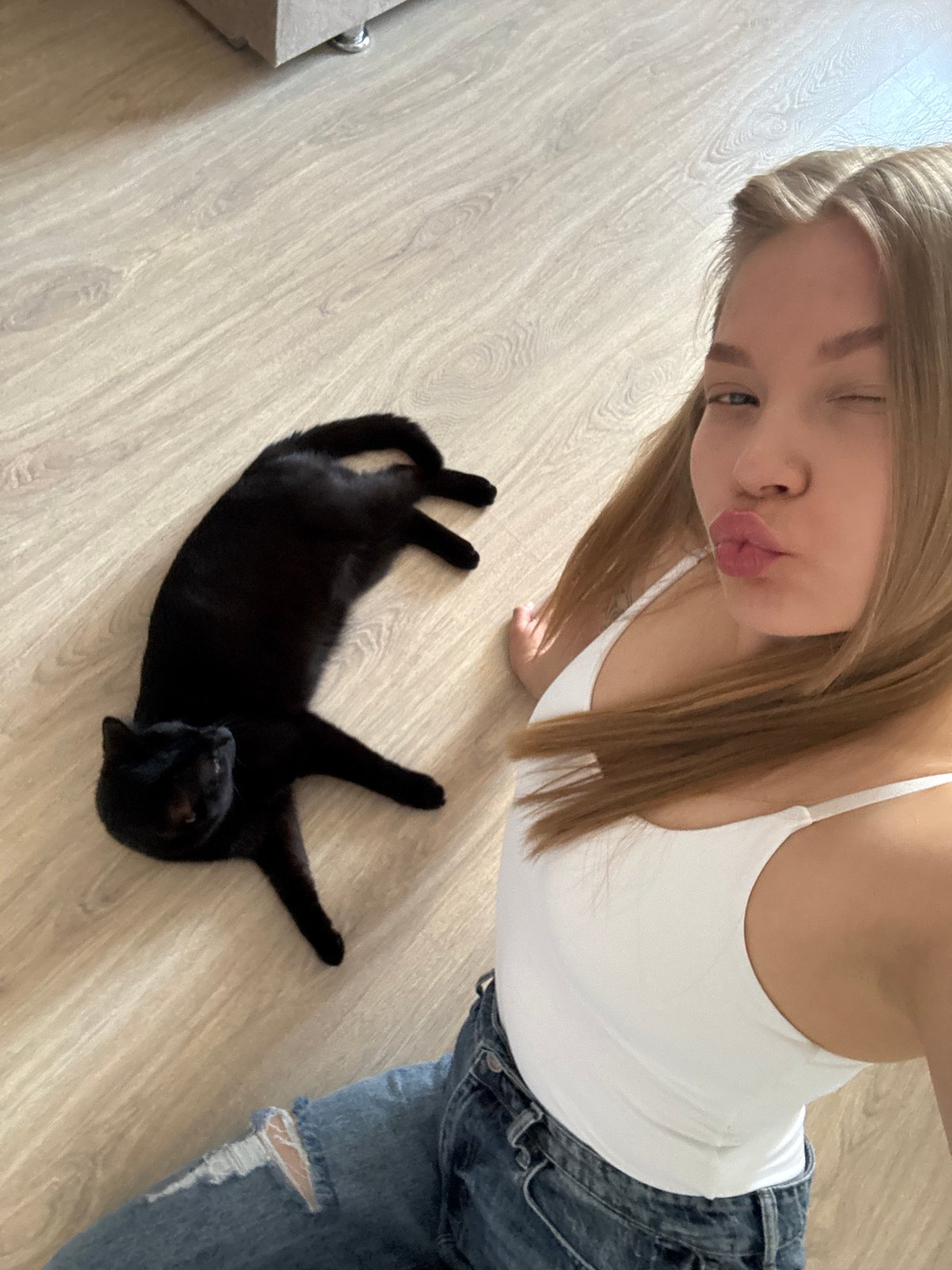 Woman takes playful selfie with cat in Chaikovsky home